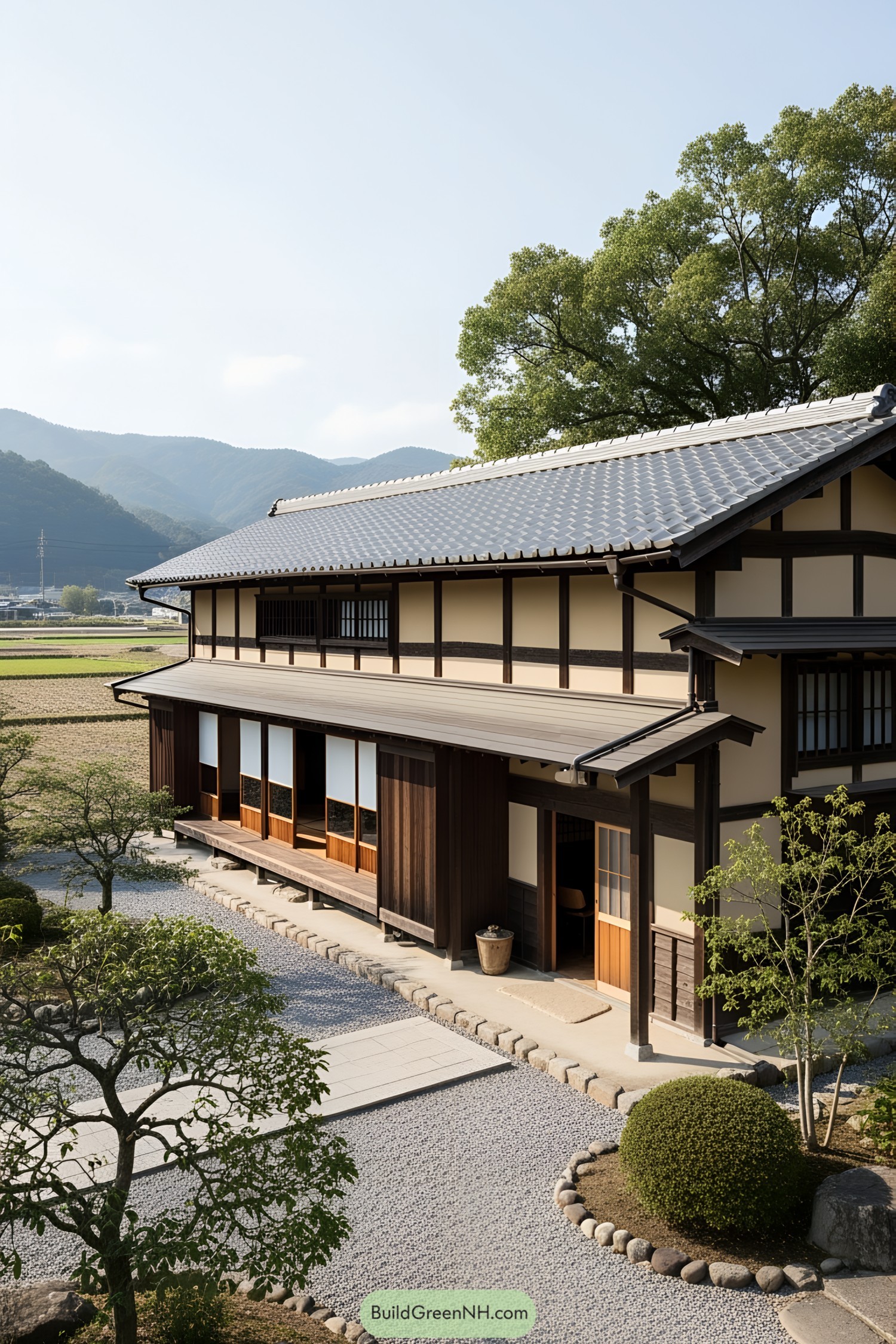 Traditional Japanese farmhouse with lush surroundings and a blue-tiled roof