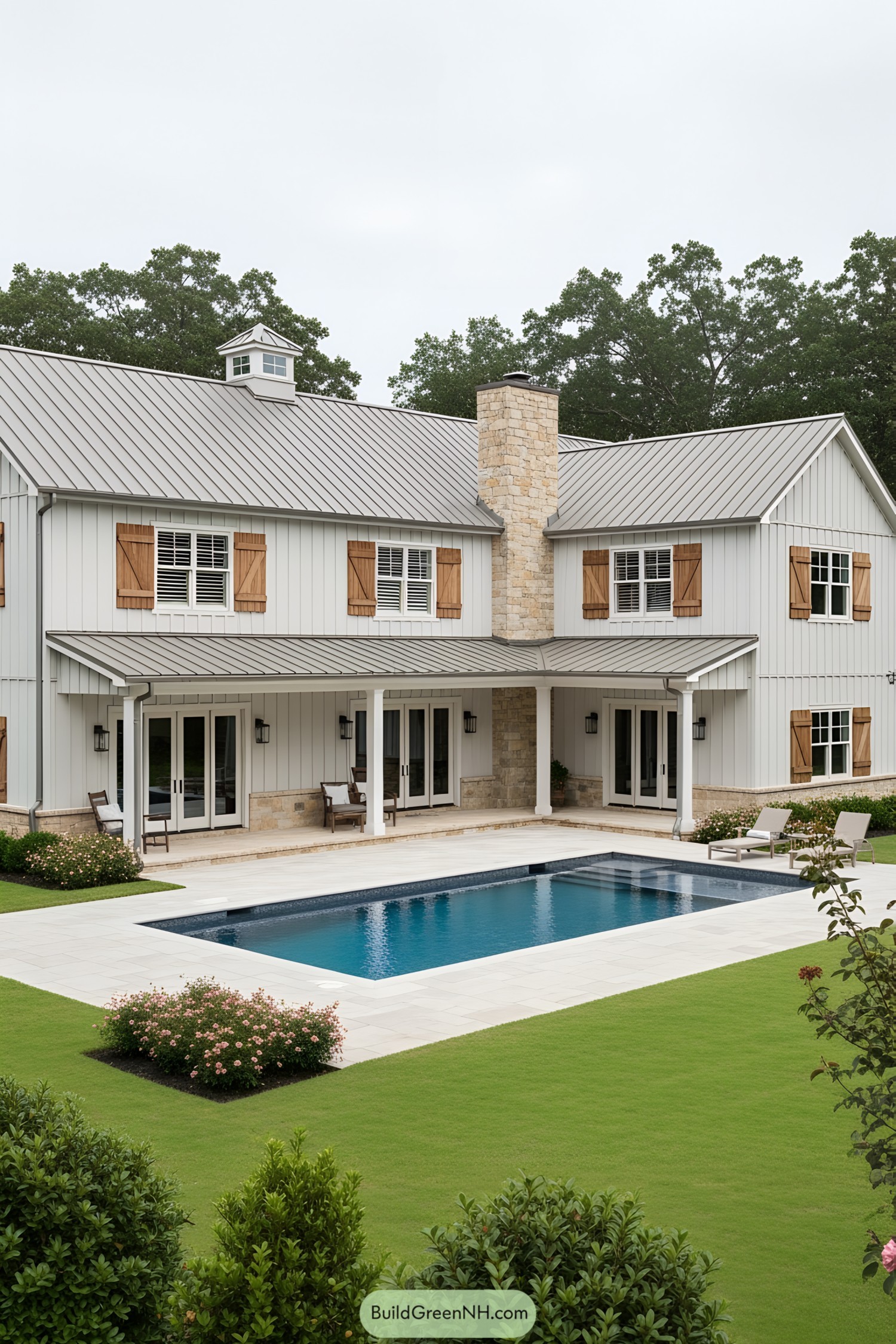 L-shaped barndominium with pool and greenery