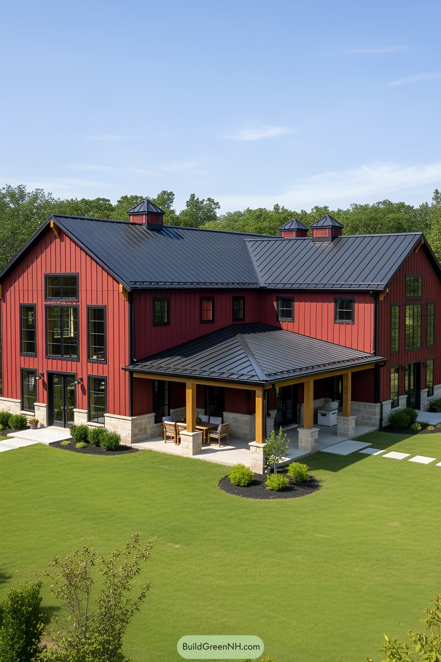 Red L-shaped house with metal roof and porch