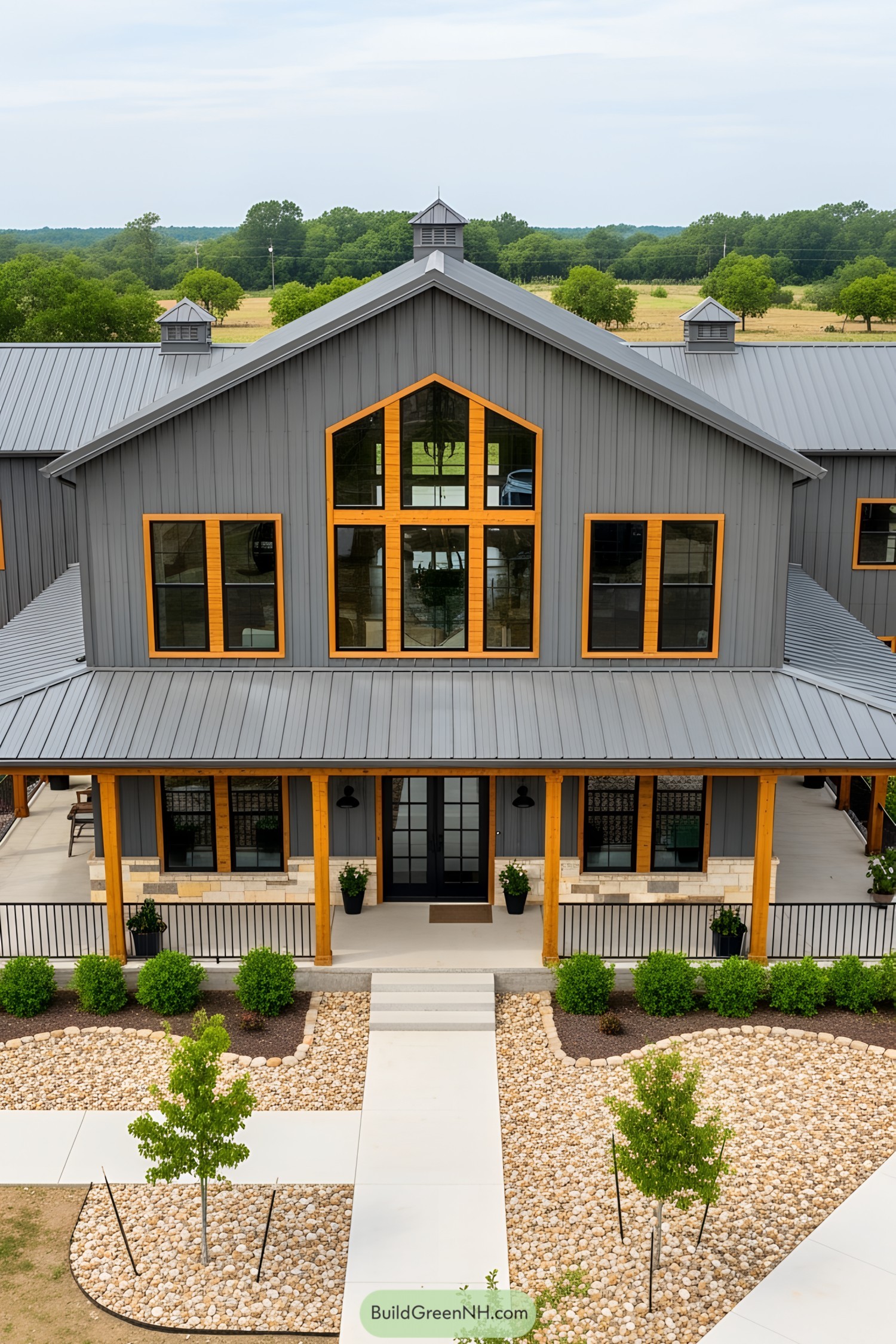Contemporary barndominium with large windows and a metal roof
