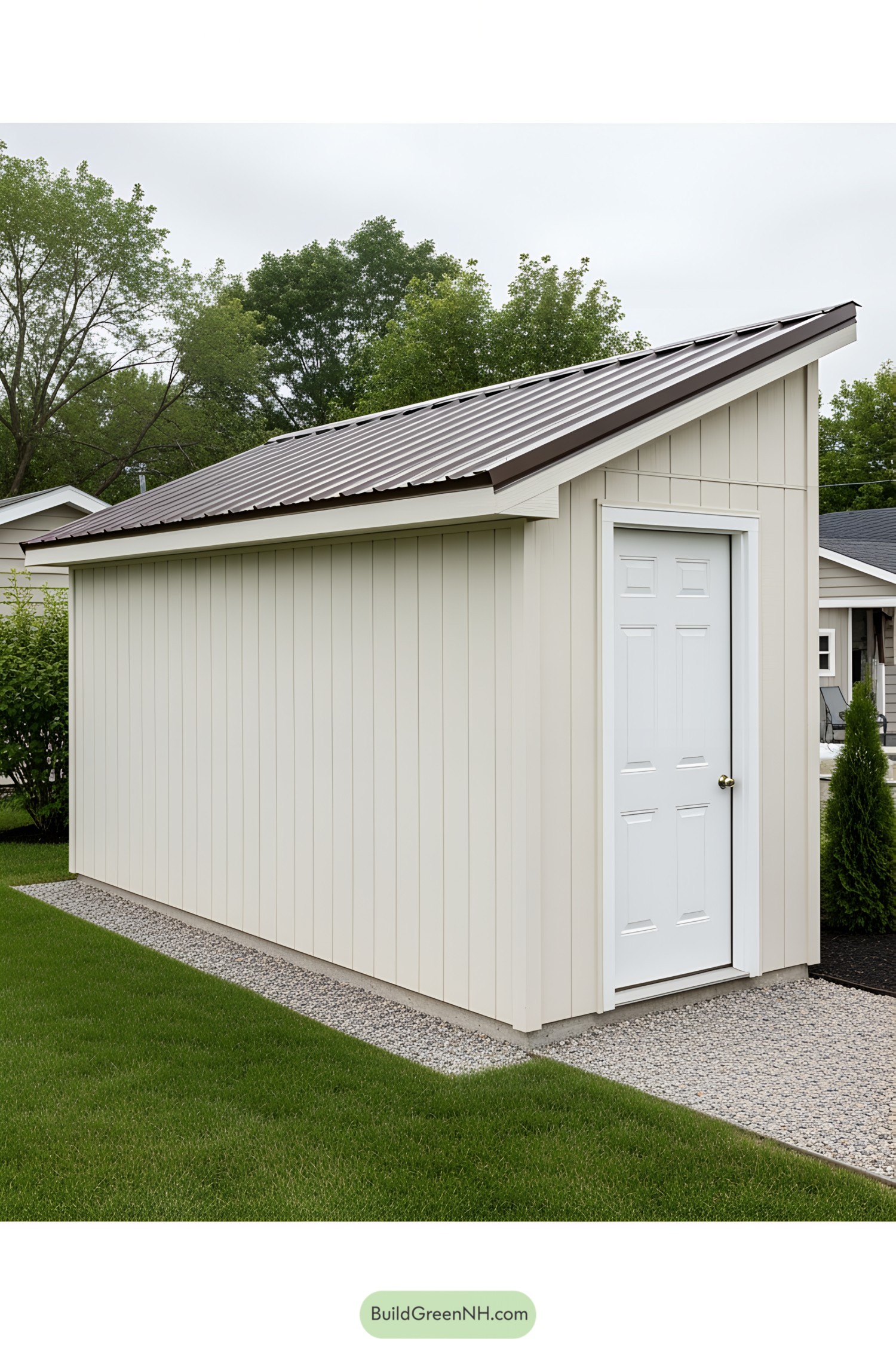 Cream-colored lean-to shed with sloping roof set against a grassy lawn