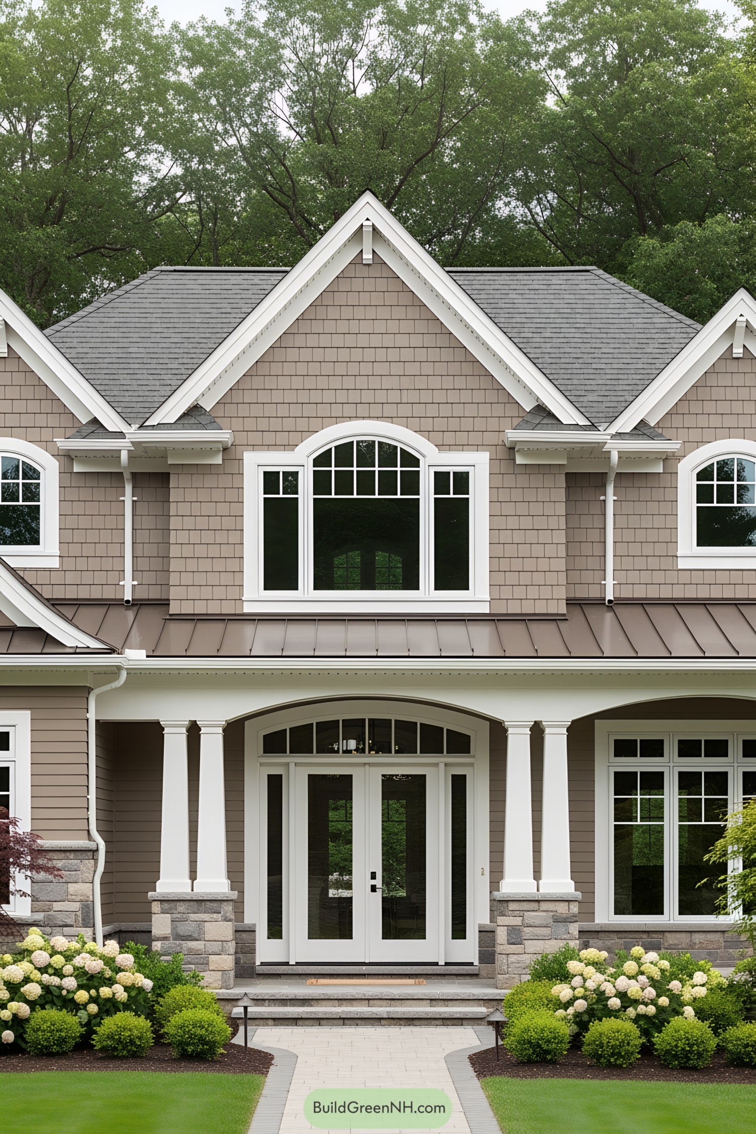 Front view of a luxury Craftsman-style house with manicured garden