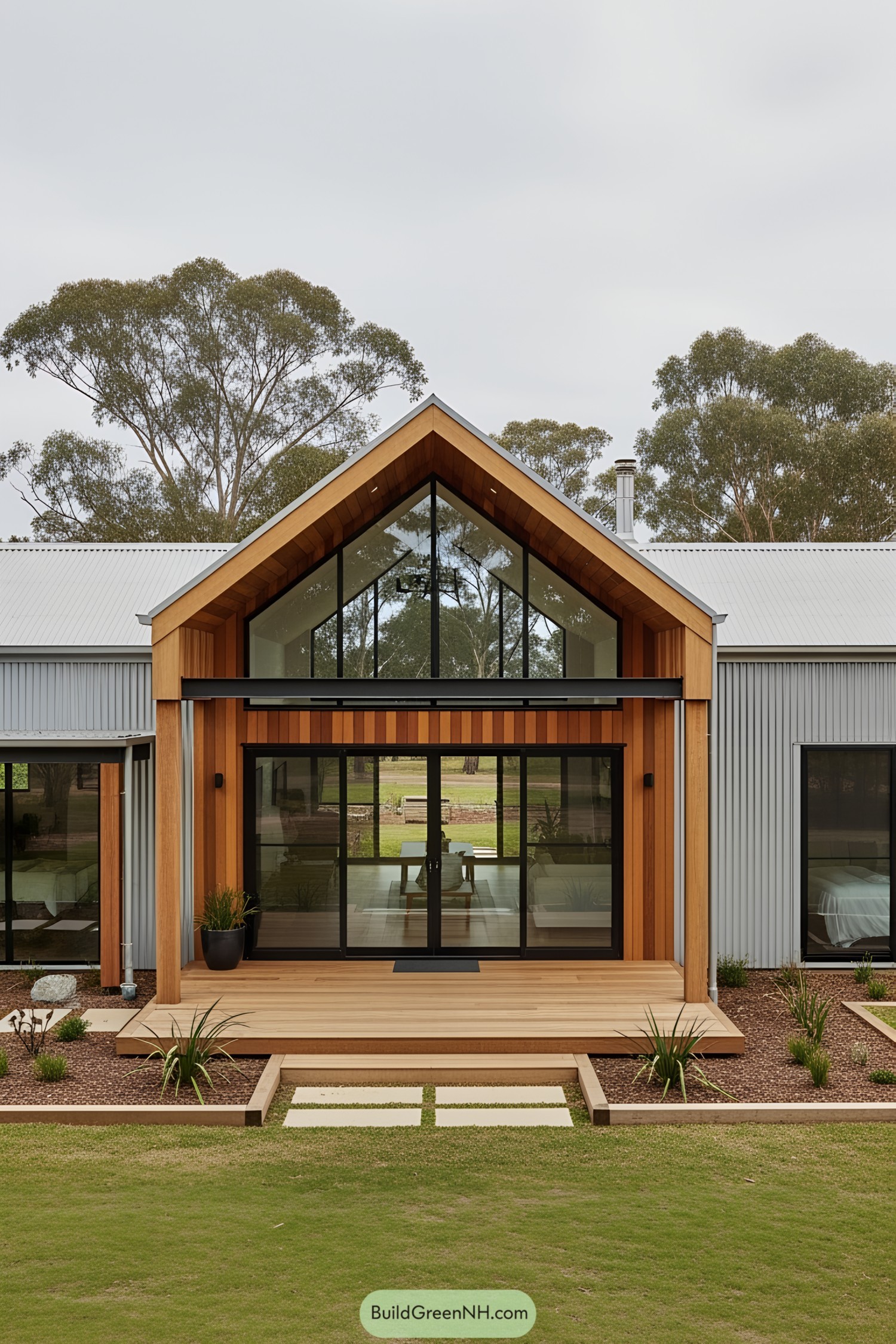 Modern farmhouse with large glass windows and a wooden deck