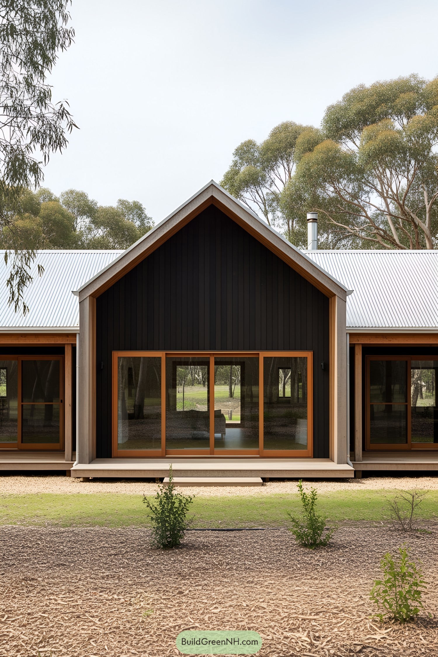 Modern Australian farmhouse with large windows and a triangular roof