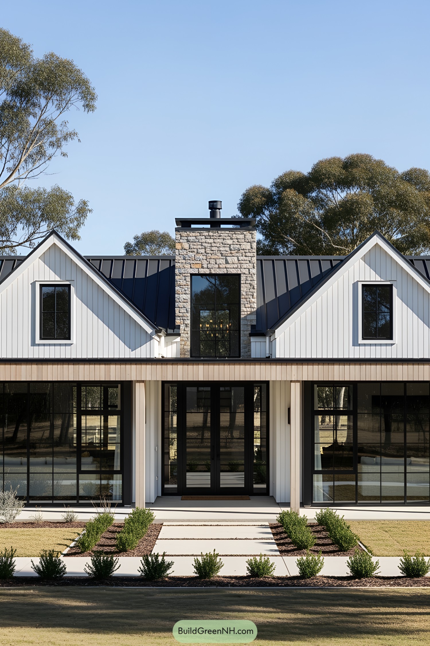 Modern farmhouse with large windows and stone chimney