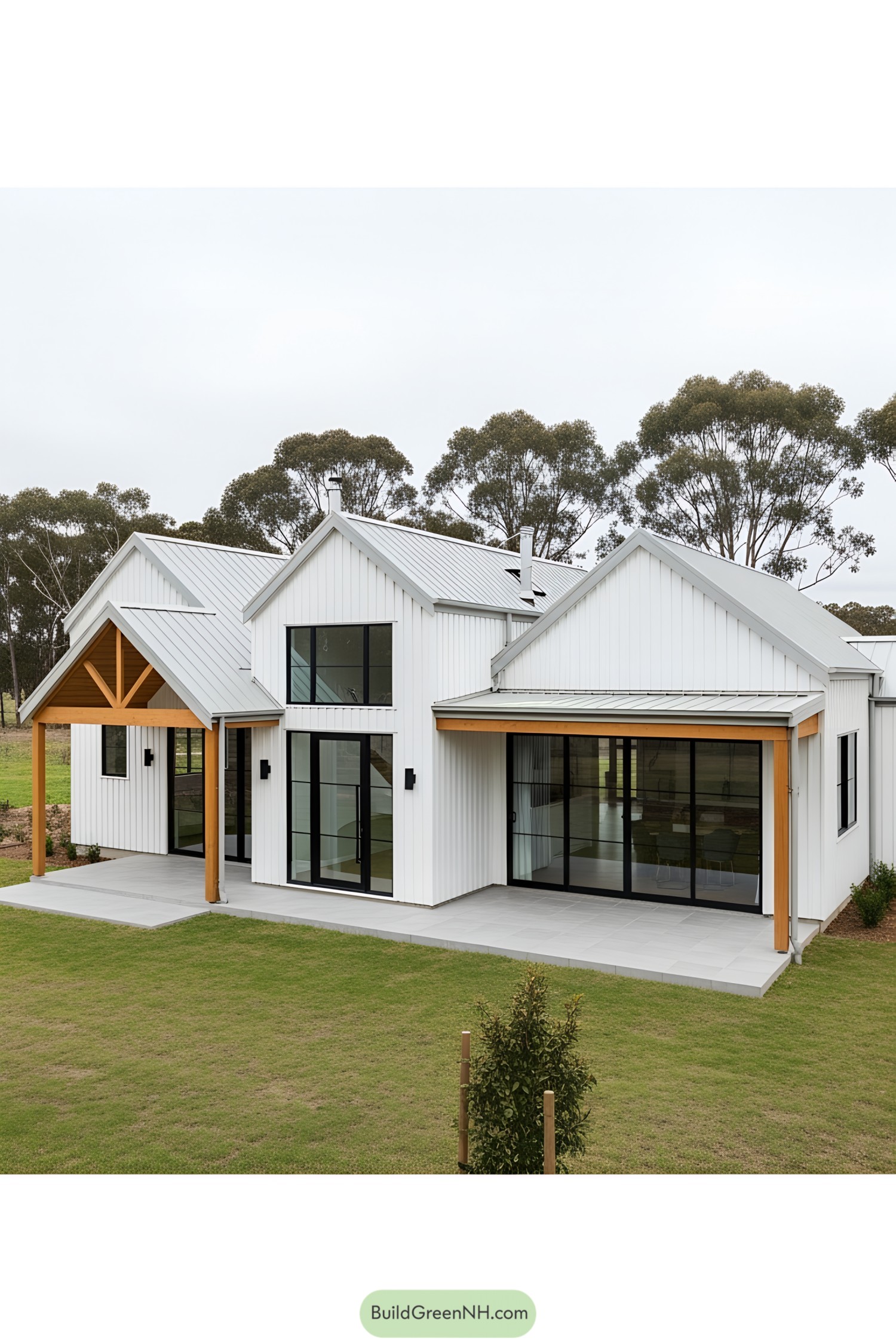 Contemporary farm-style house with white paneling and large windows