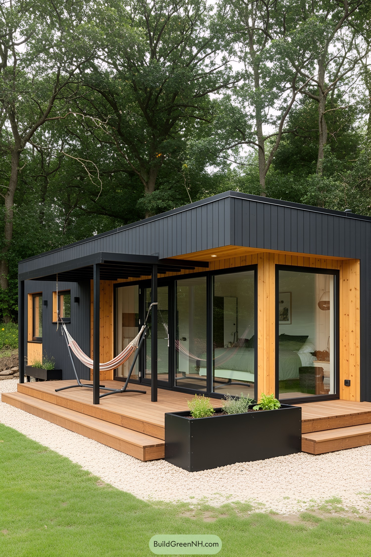 Modern micro cabin with black and wood exterior, featuring a hammock and large windows