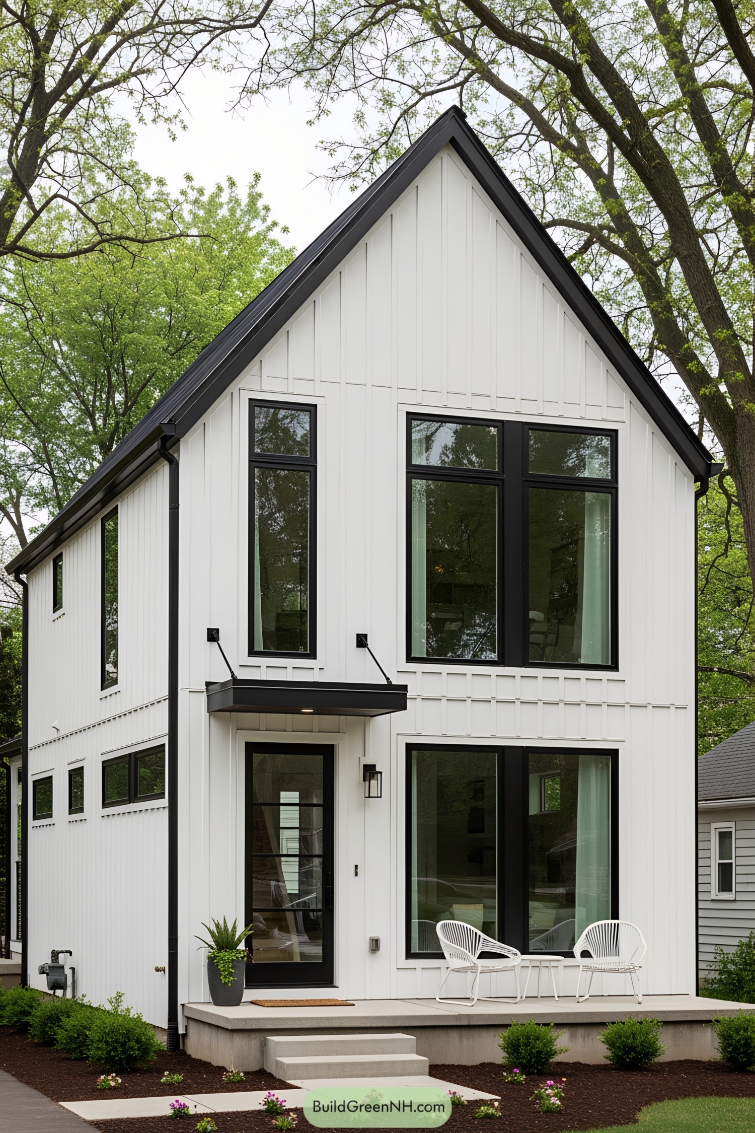 Compact modern house with black trim and large windows