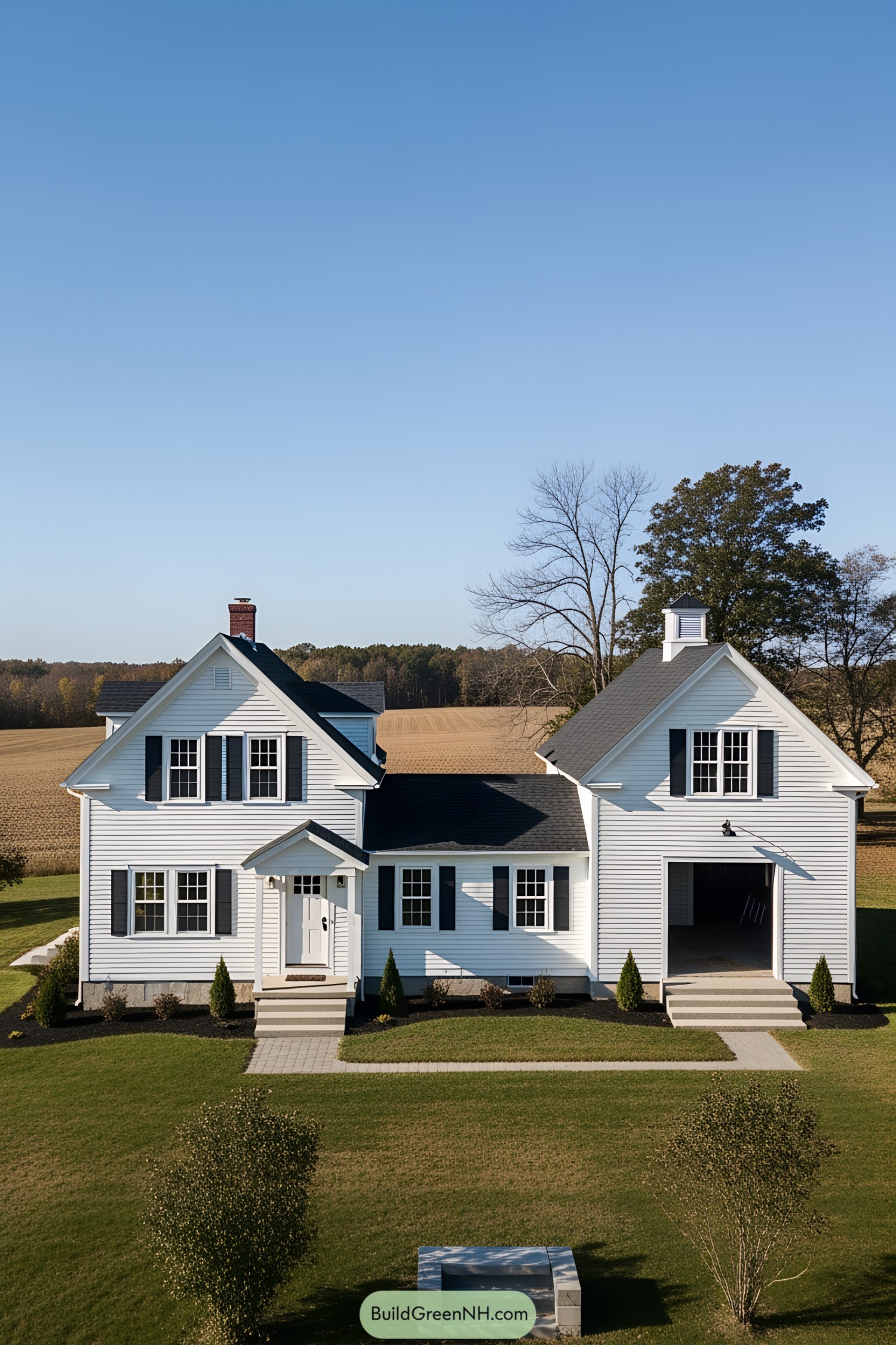 Beautiful white farmhouse with black shutters in a rural setting
