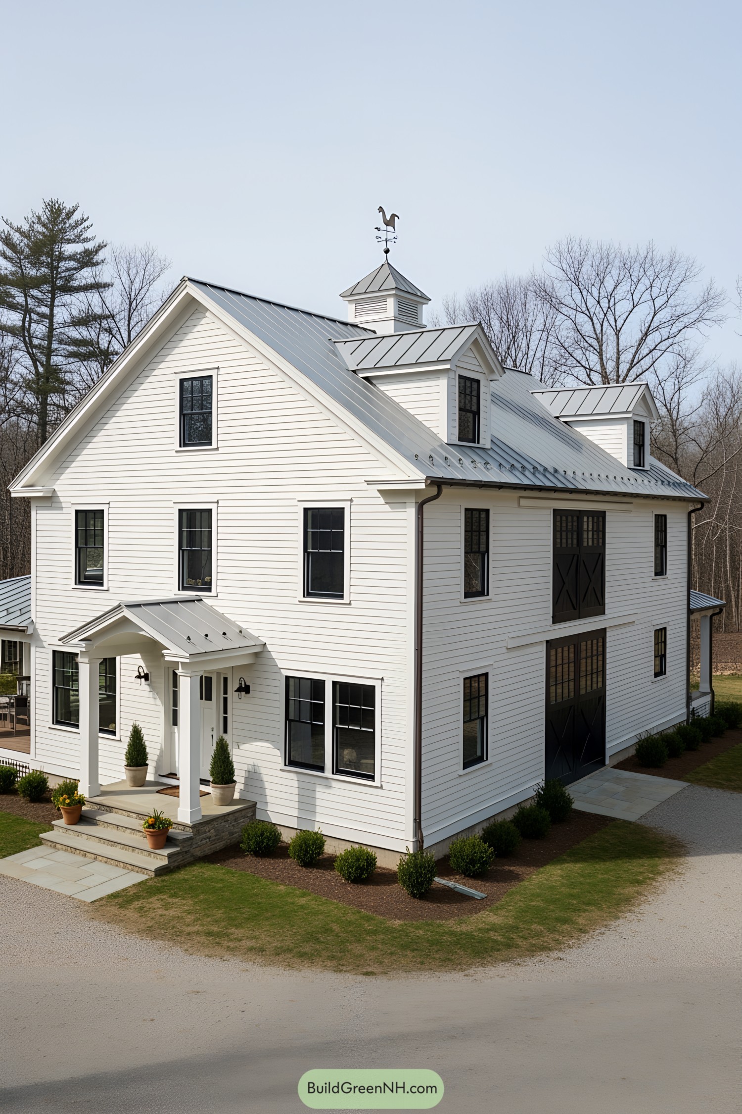 White farmhouse with metal roof and rooster weathervane
