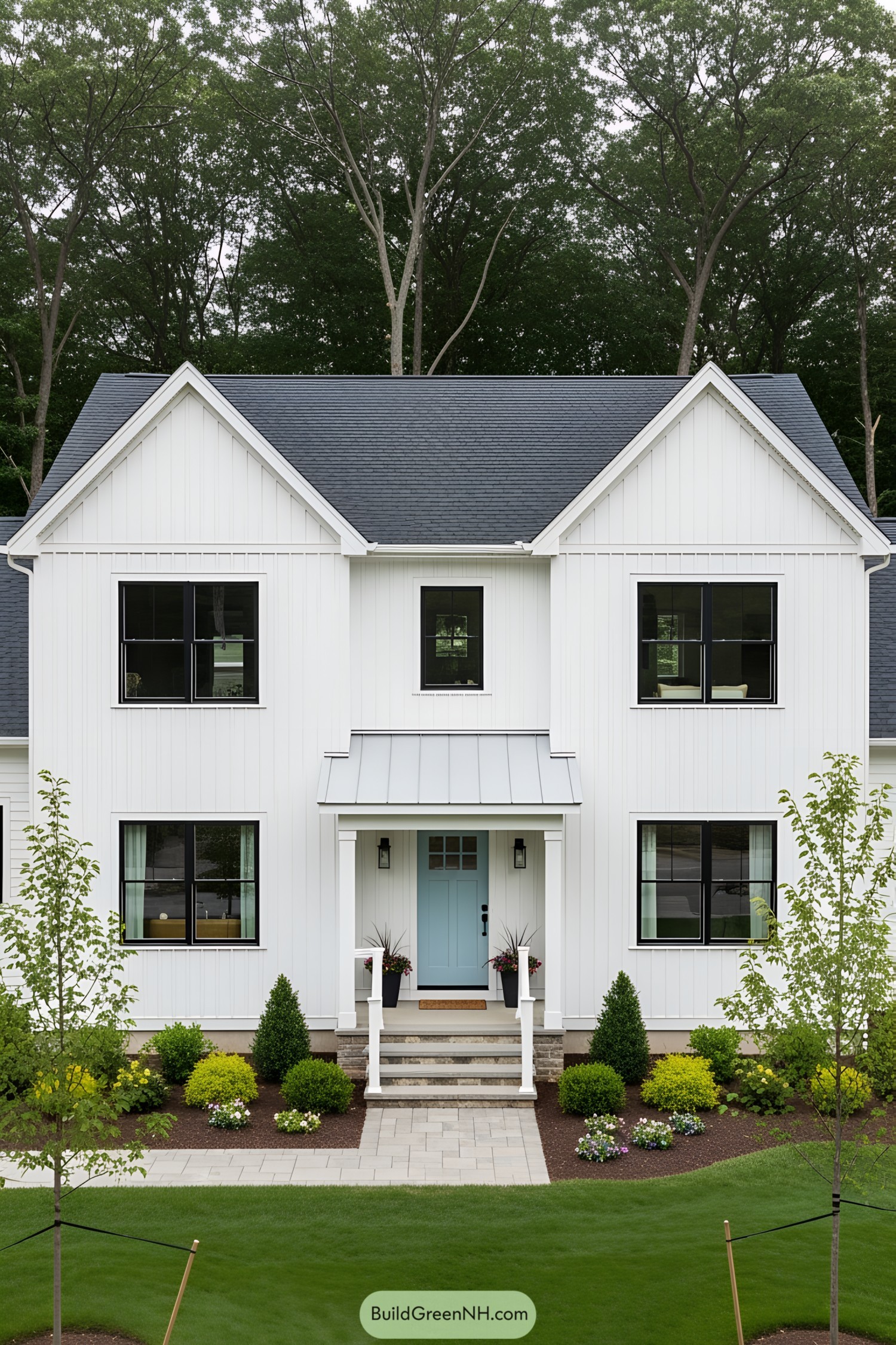 White farmhouse with blue door and black windows