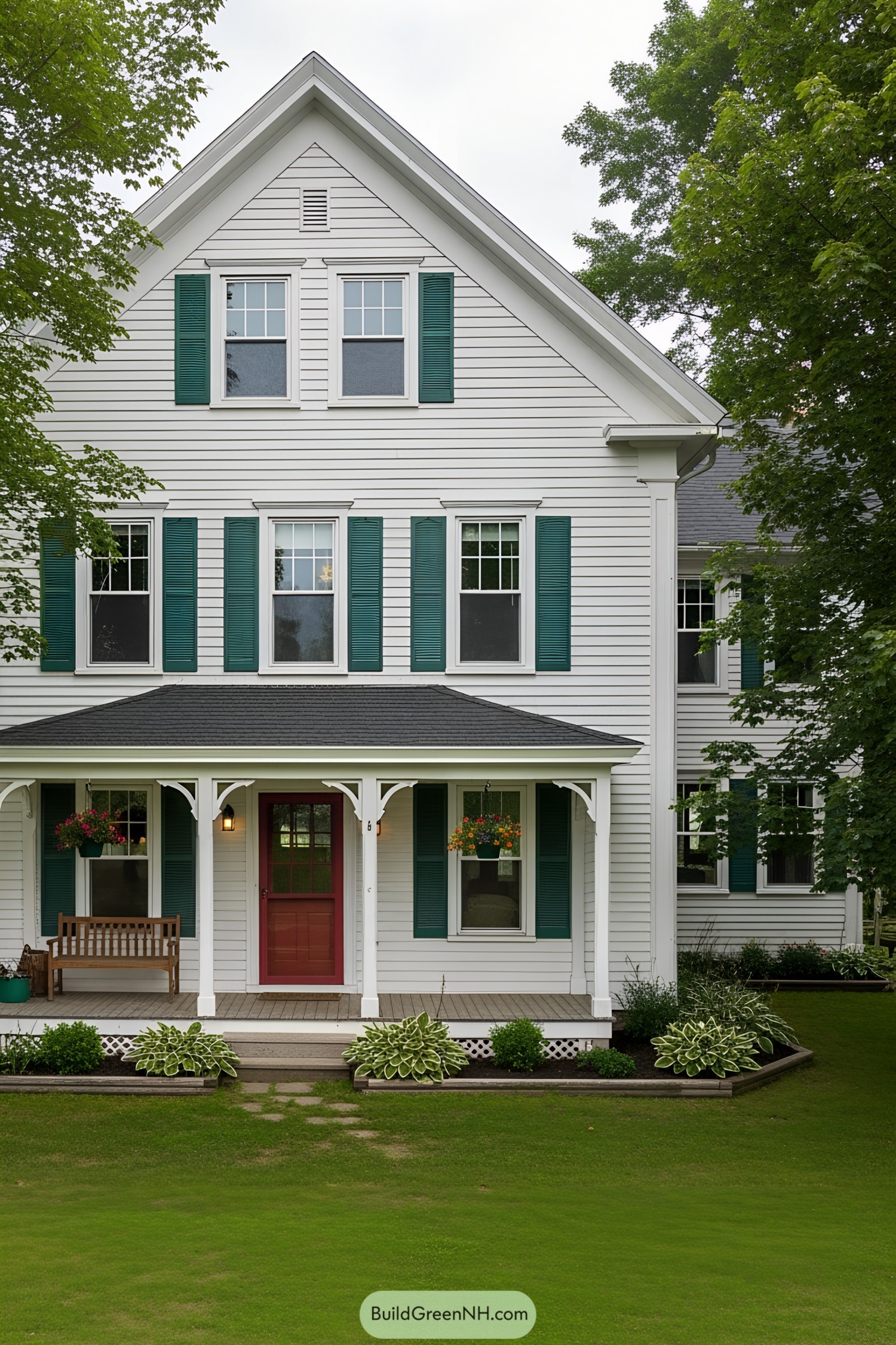 White farmhouse with green shutters and a red door