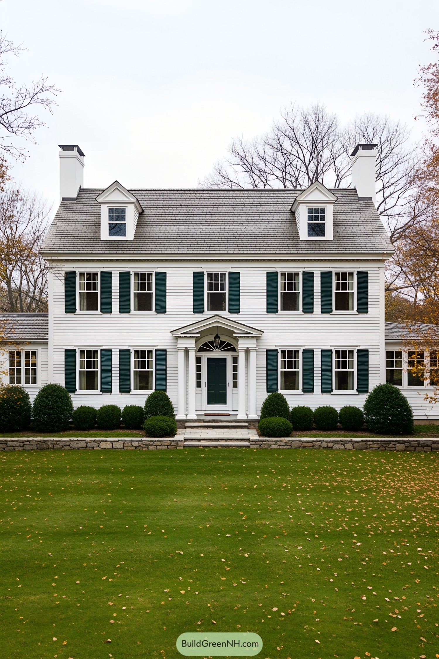 White colonial farmhouse with dark green shutters