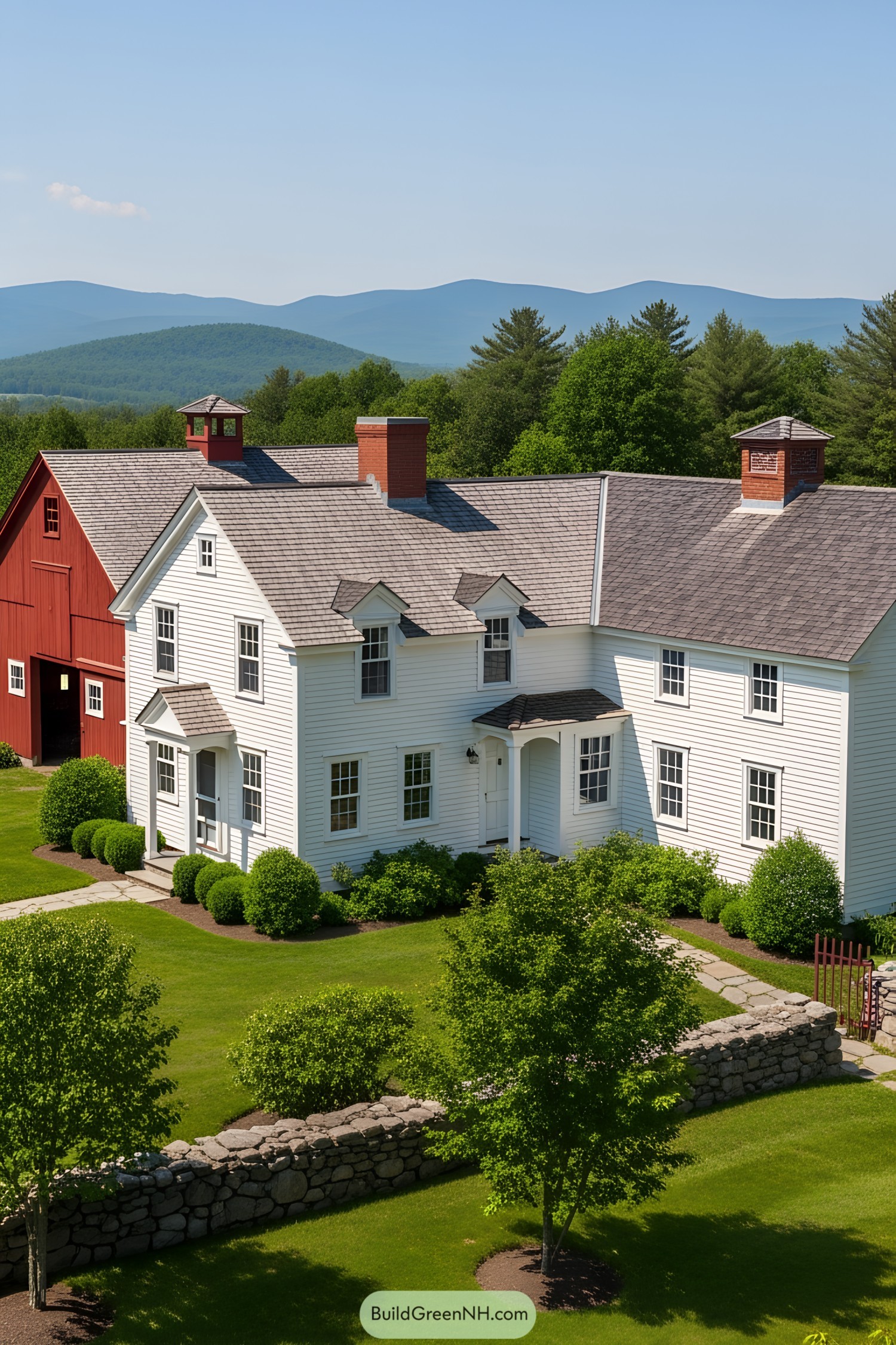 White farmhouse with red barn and distant hills