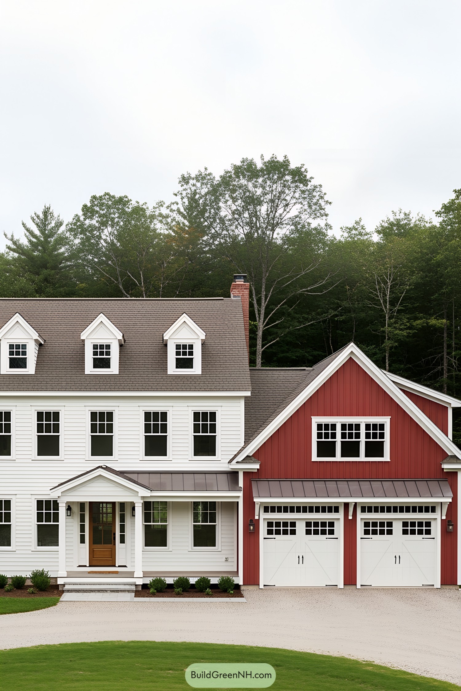 White and red farmhouse with dormer windows and two-car garage