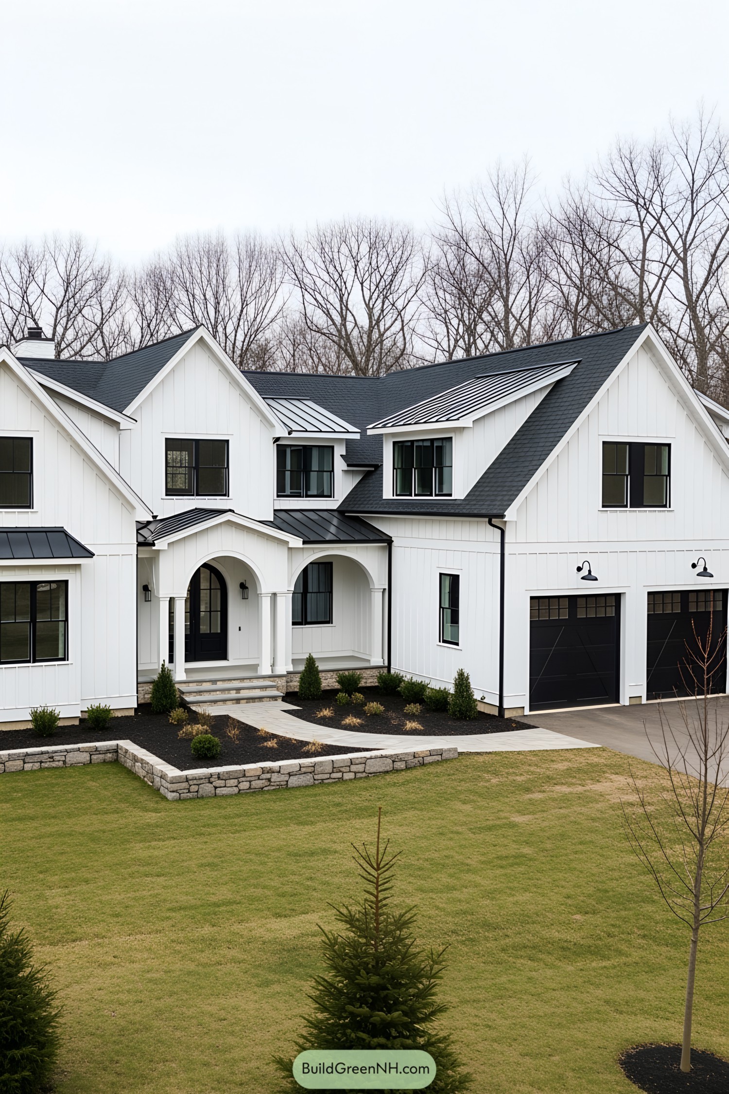 White farmhouse with black trim and a driveway