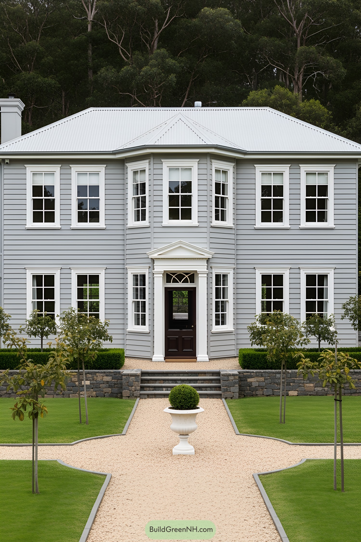 Classic old cottage with a gray exterior and lush surroundings