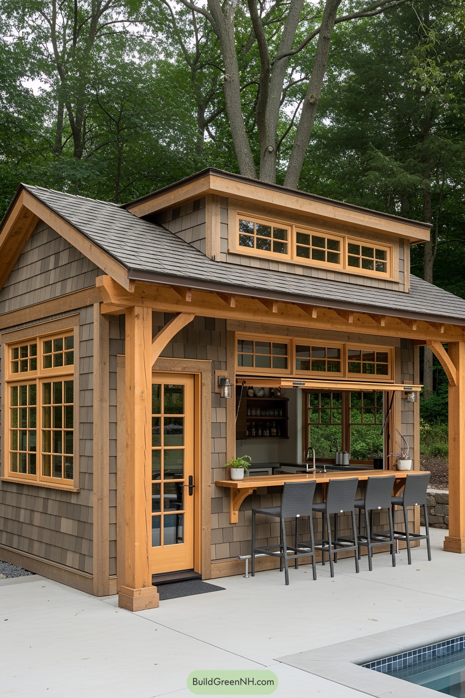Compact wood-clad pool house with bar and stools