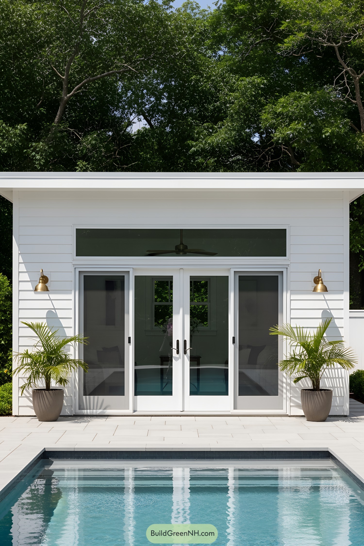 Modern pool house with sliding doors and lush greenery