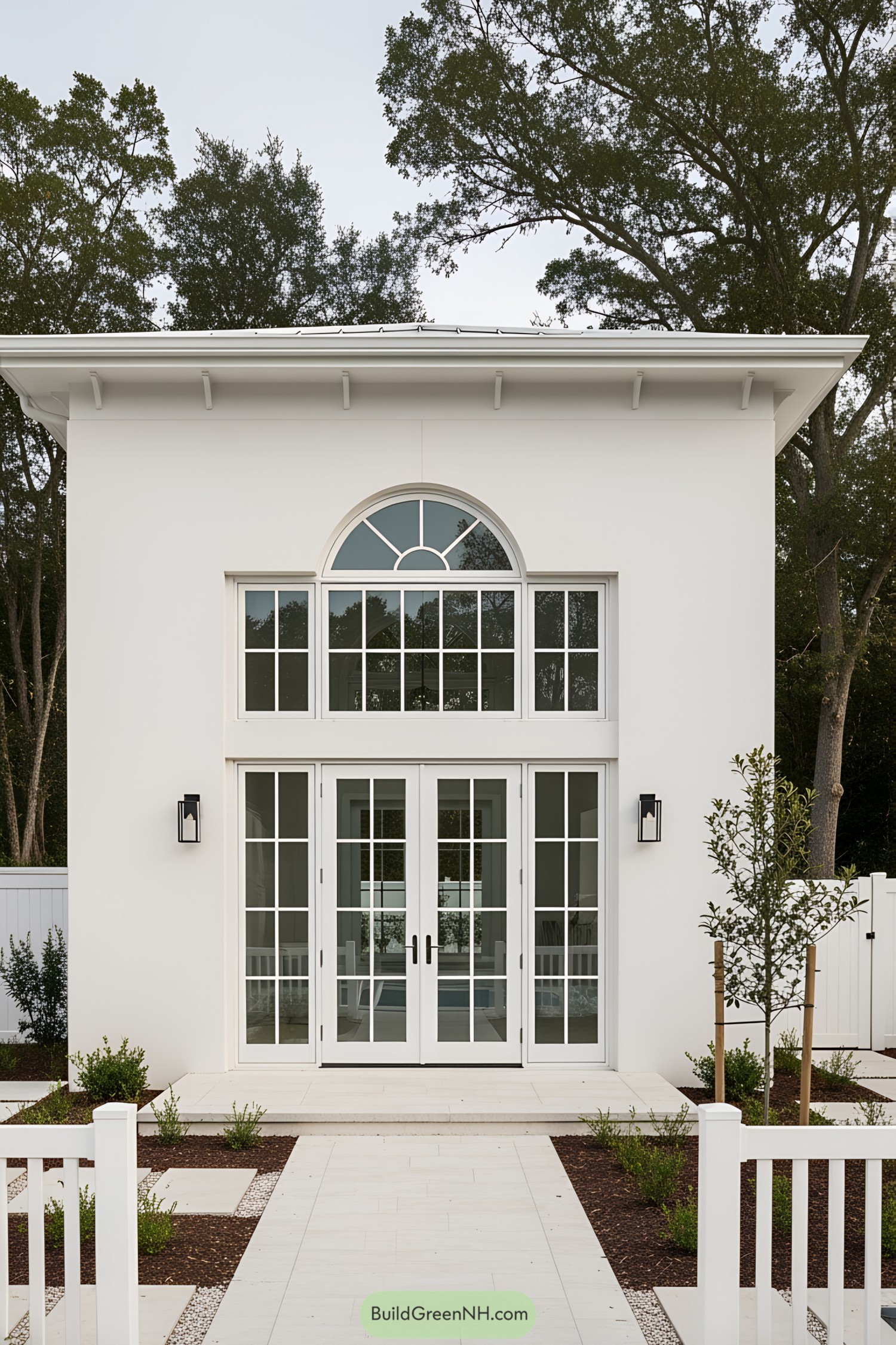 Elegant white pool house with large glass doors