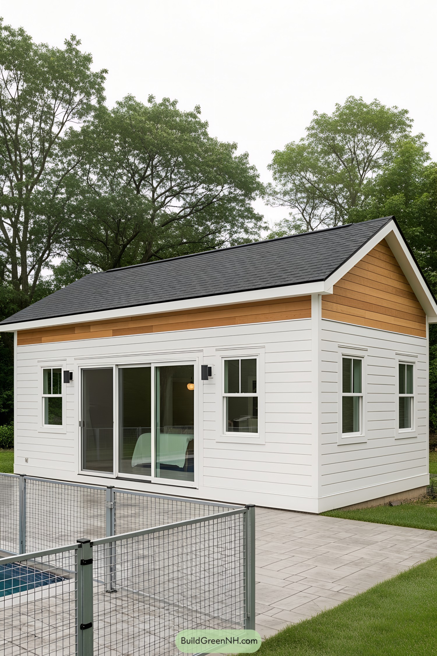 Compact pool house with white siding and a dark roof