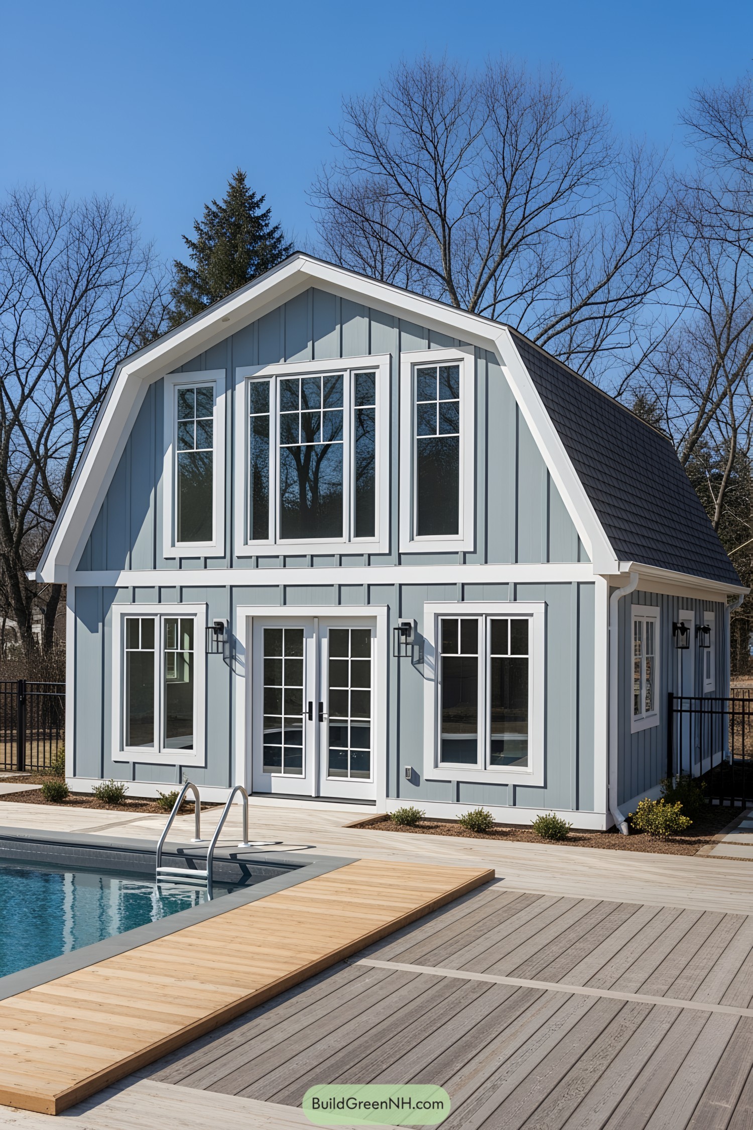 Stylish poolside guest house with a modern design, next to a clear blue pool