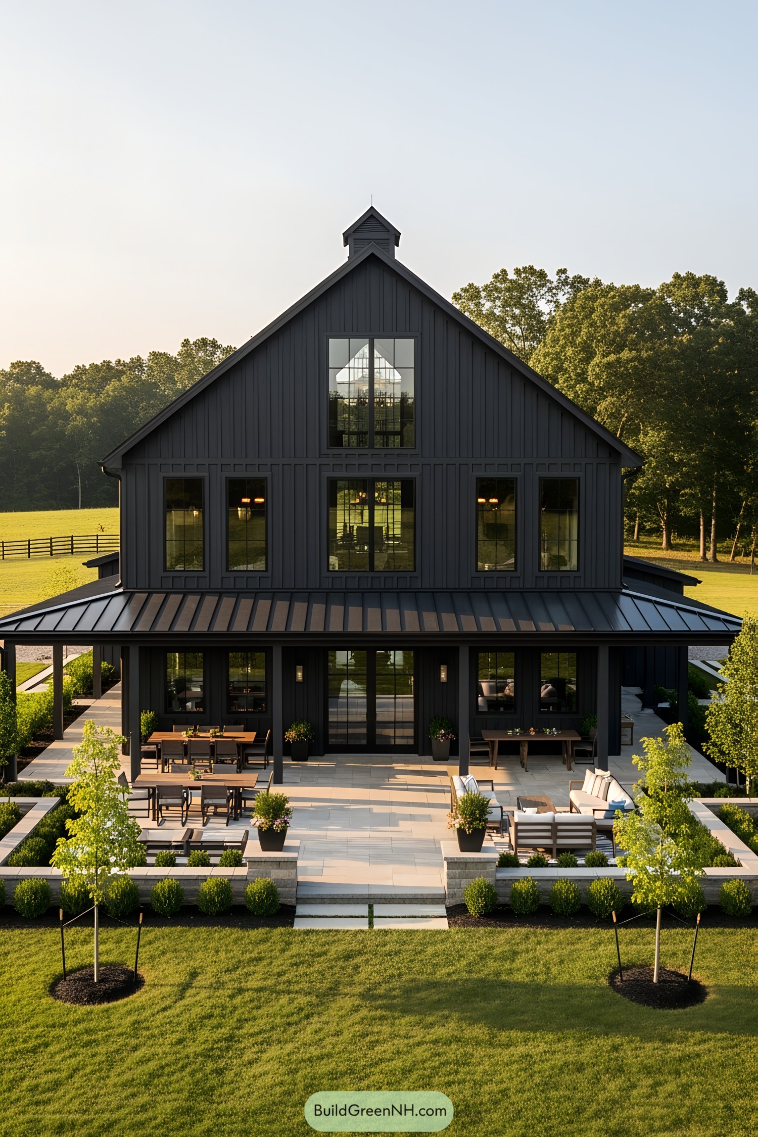 Modern barn-style house with spacious patio and lush greenery