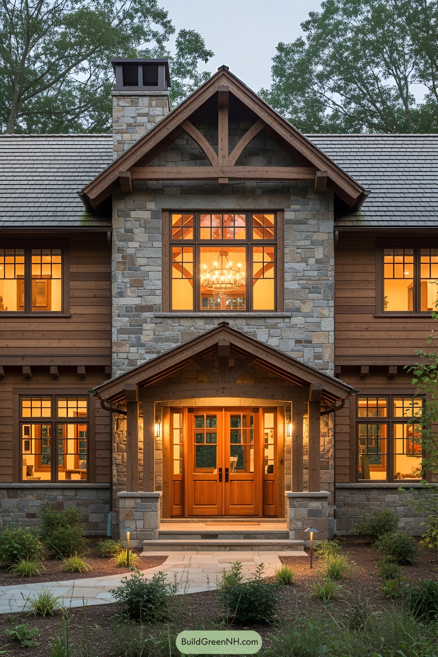A Craftsman-style house with warm lighting and lush greenery