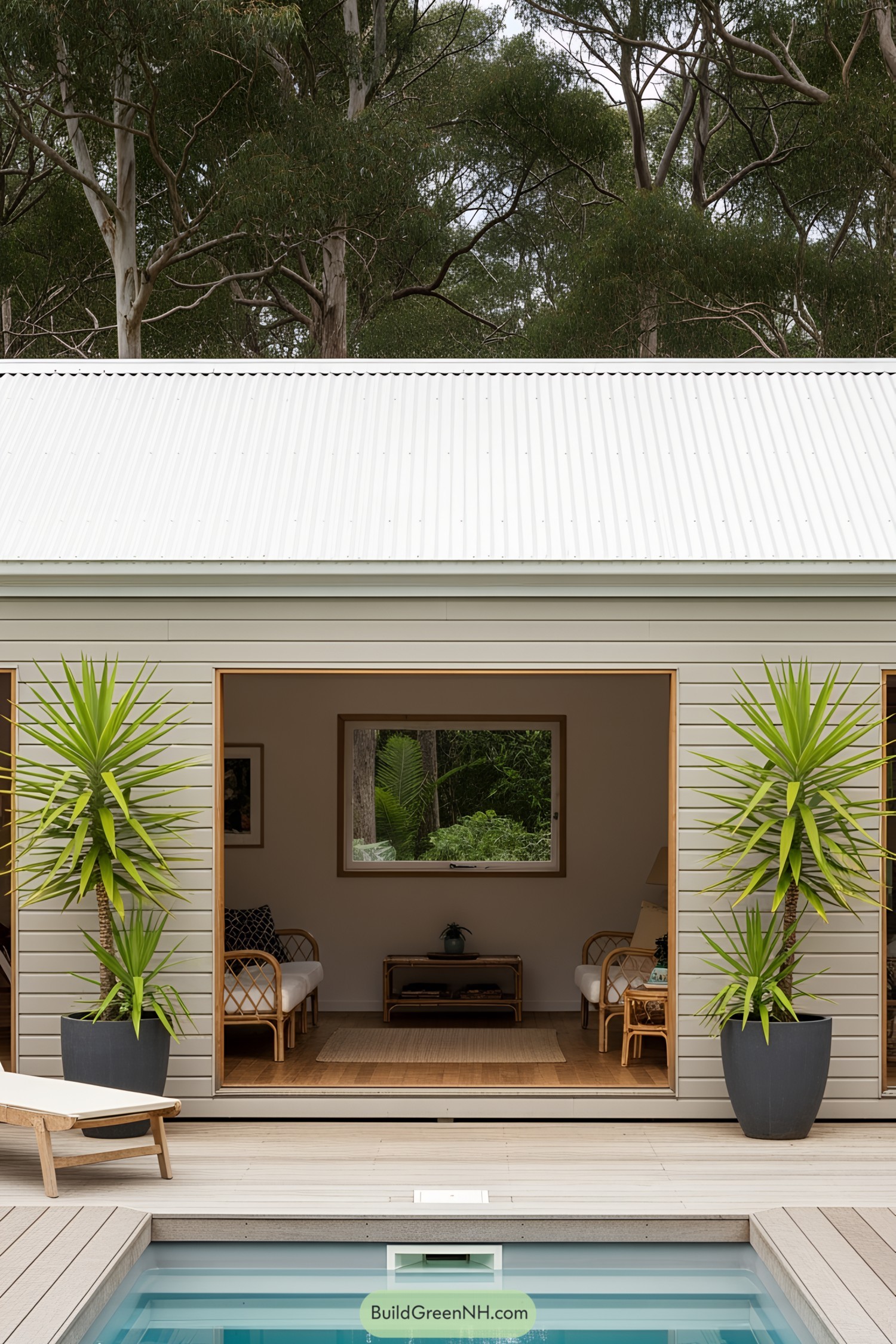 Compact pool house with white siding and potted plants
