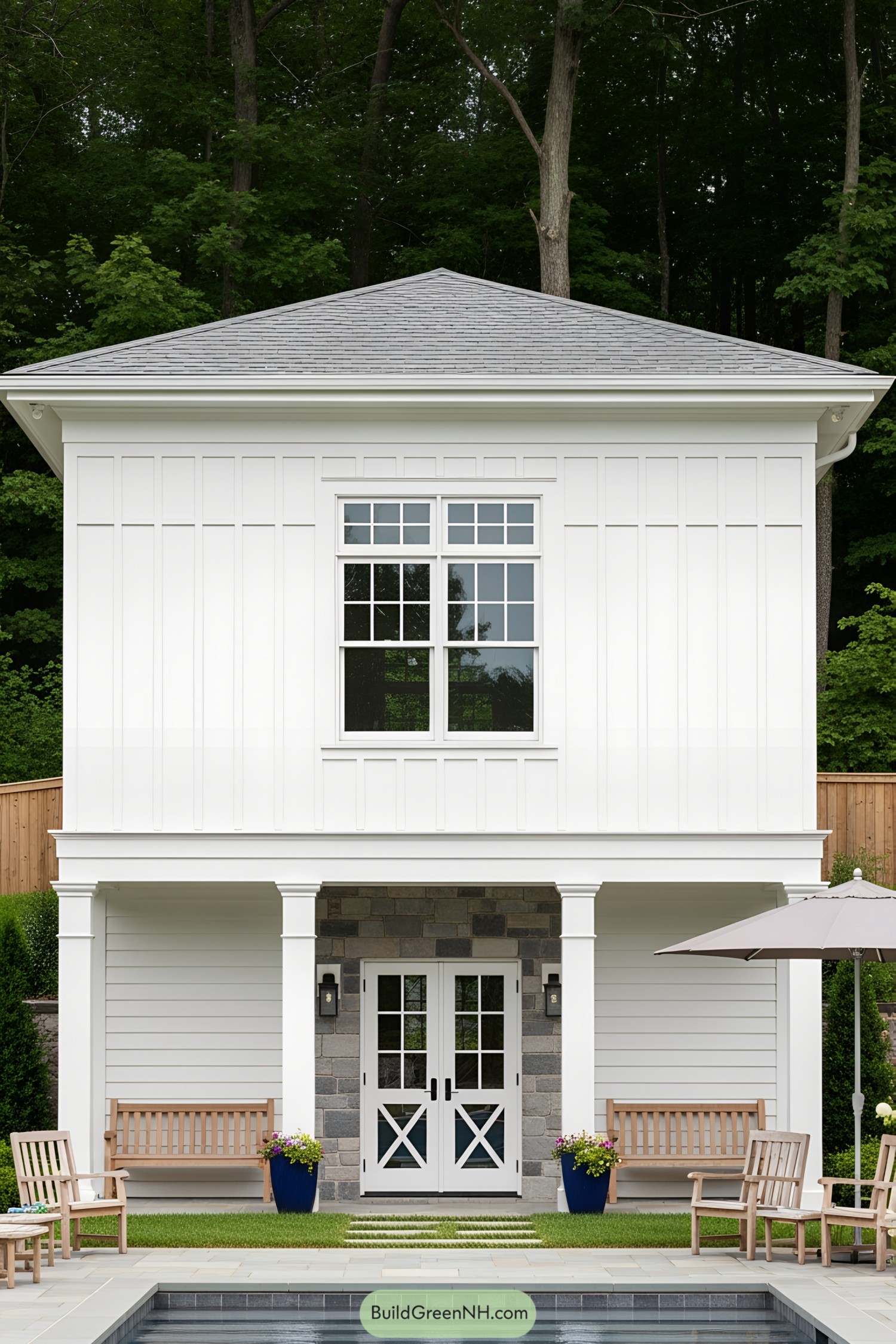 White pool house with large window and double doors