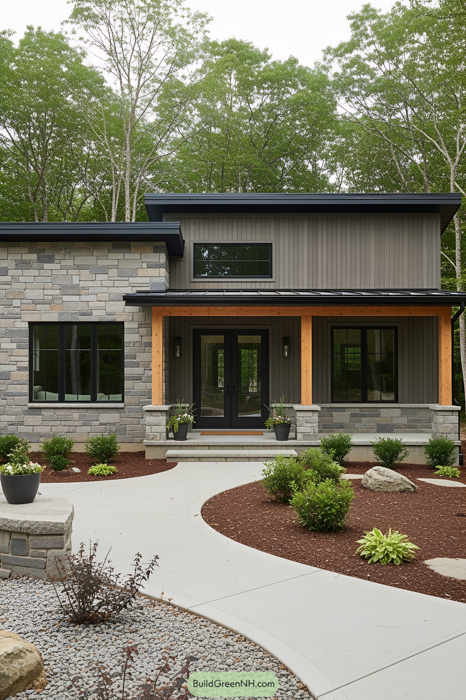 Contemporary cottage with stone accents surrounded by trees