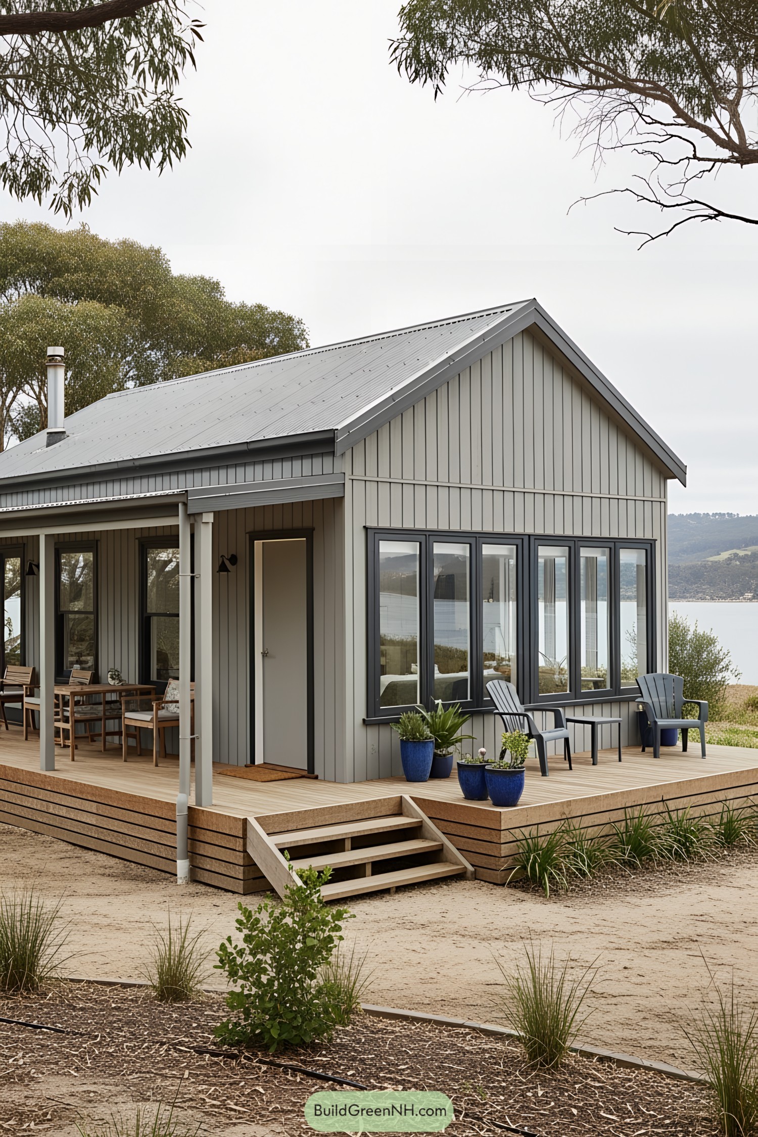 Small gray beach house with a cozy porch and ocean view