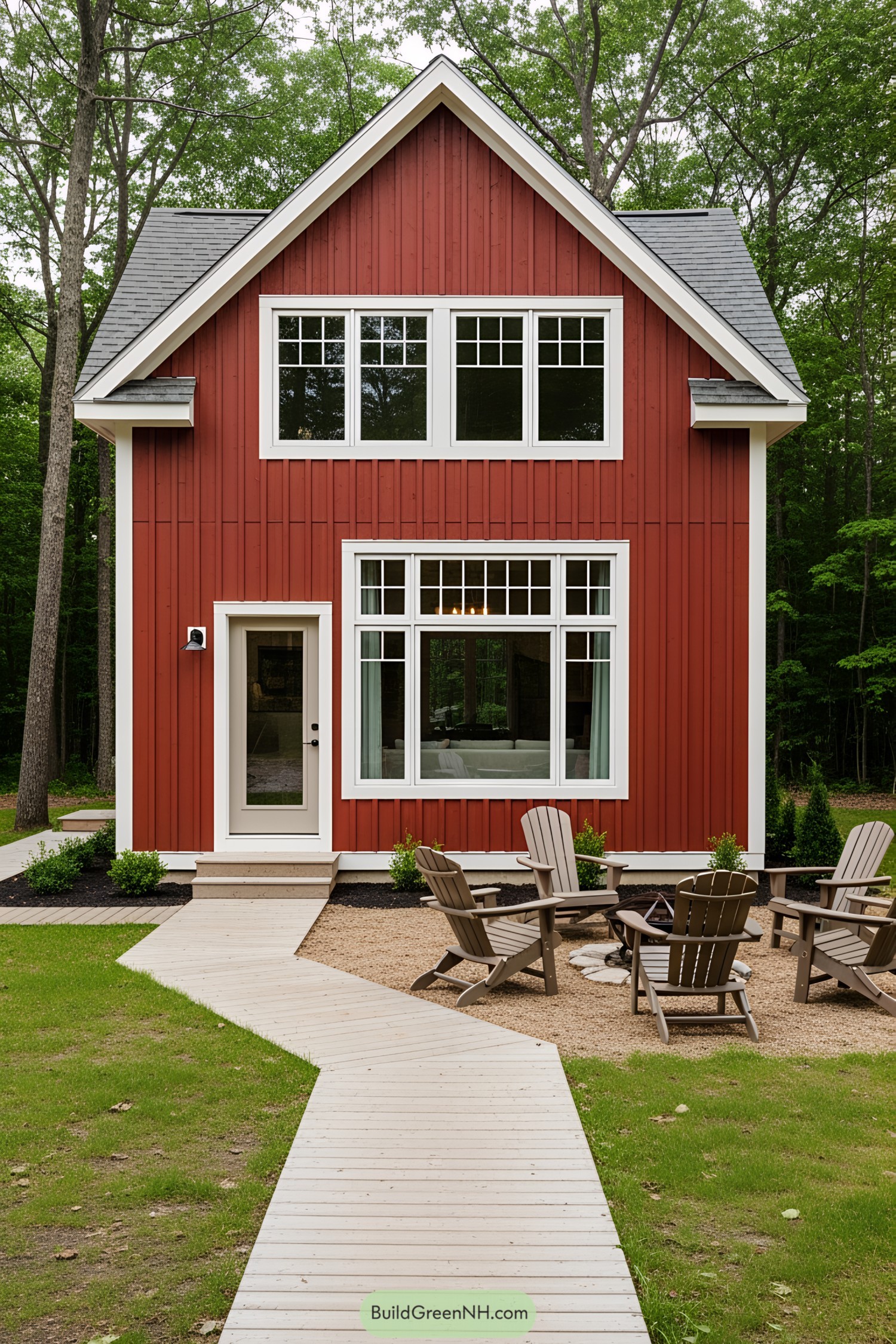 Small red cottage with large windows and a patio area