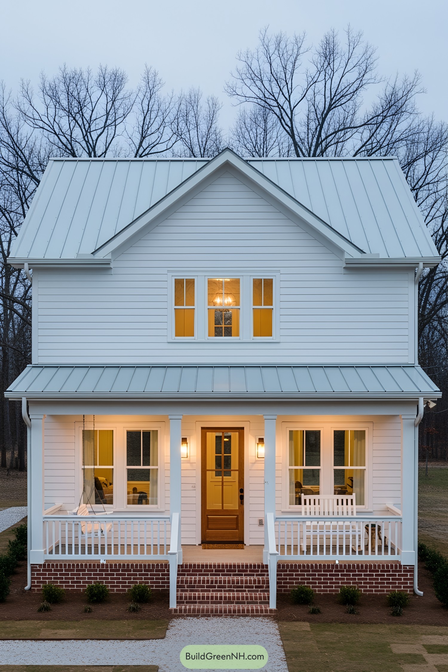 Cozy white farmhouse with porch during twilight
