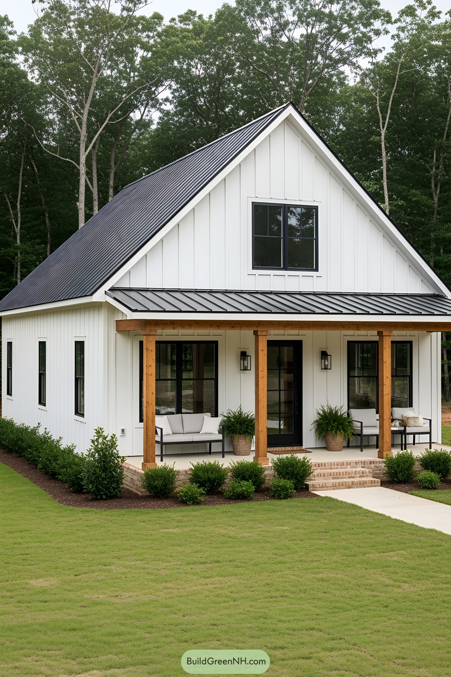 Farmhouse with black metal roof and front porch