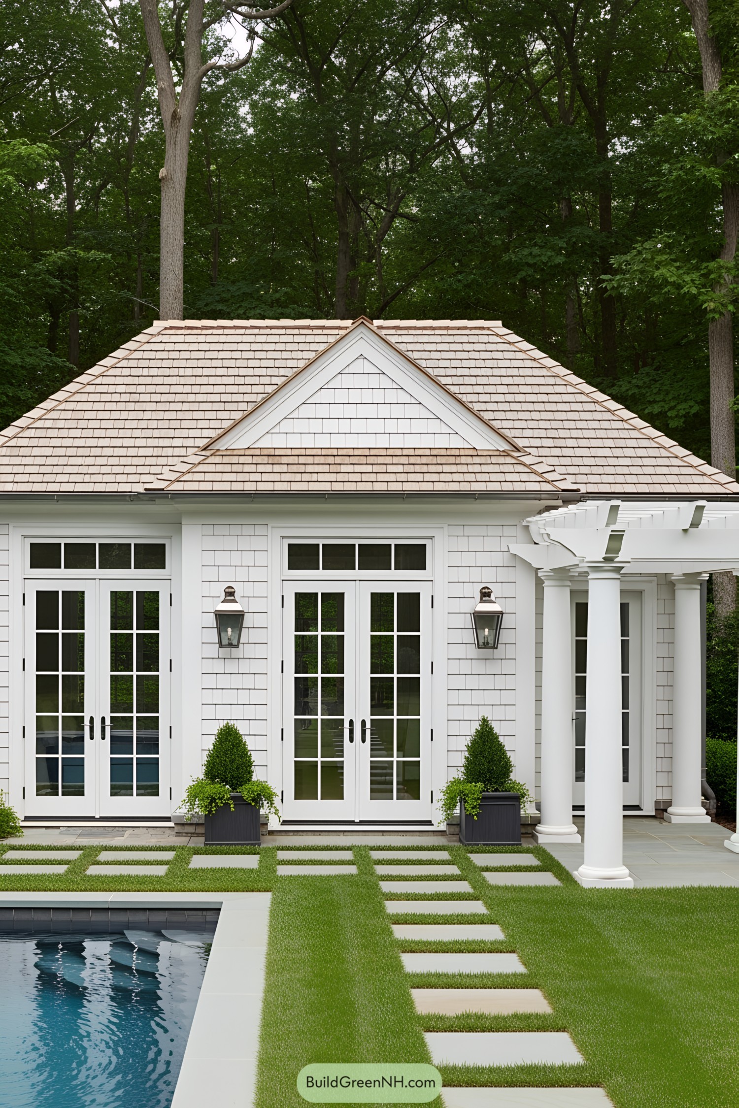 Small pool house with white siding and glass doors