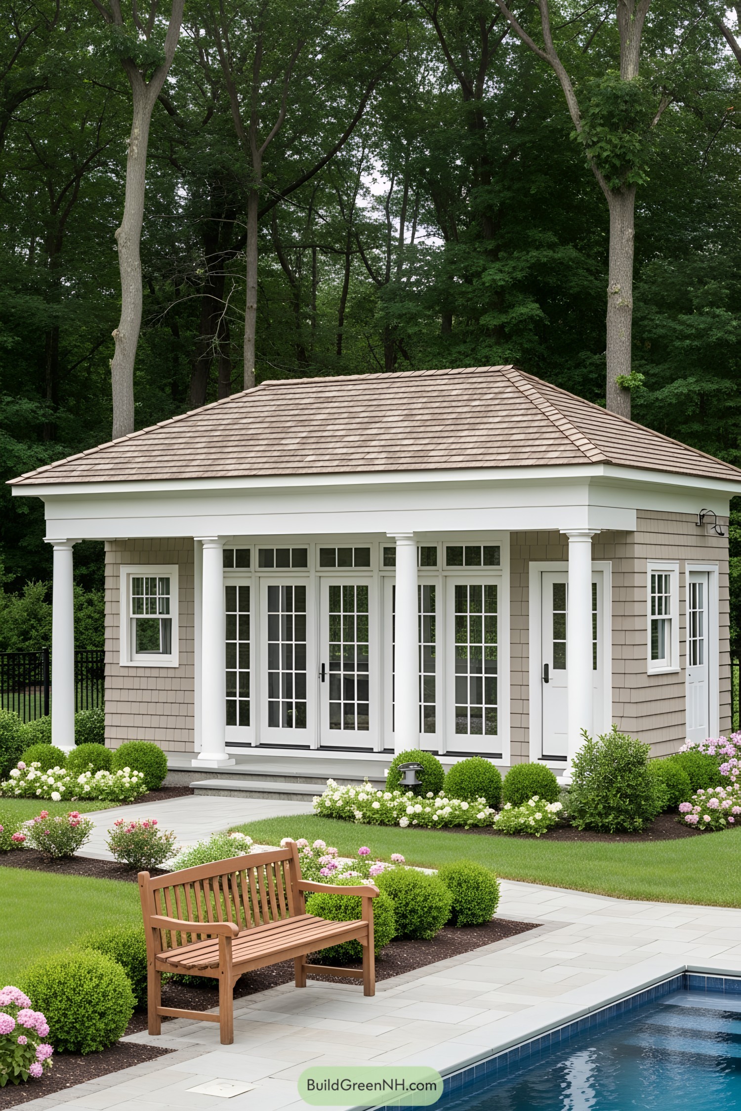 Charming small pool house surrounded by lush greenery