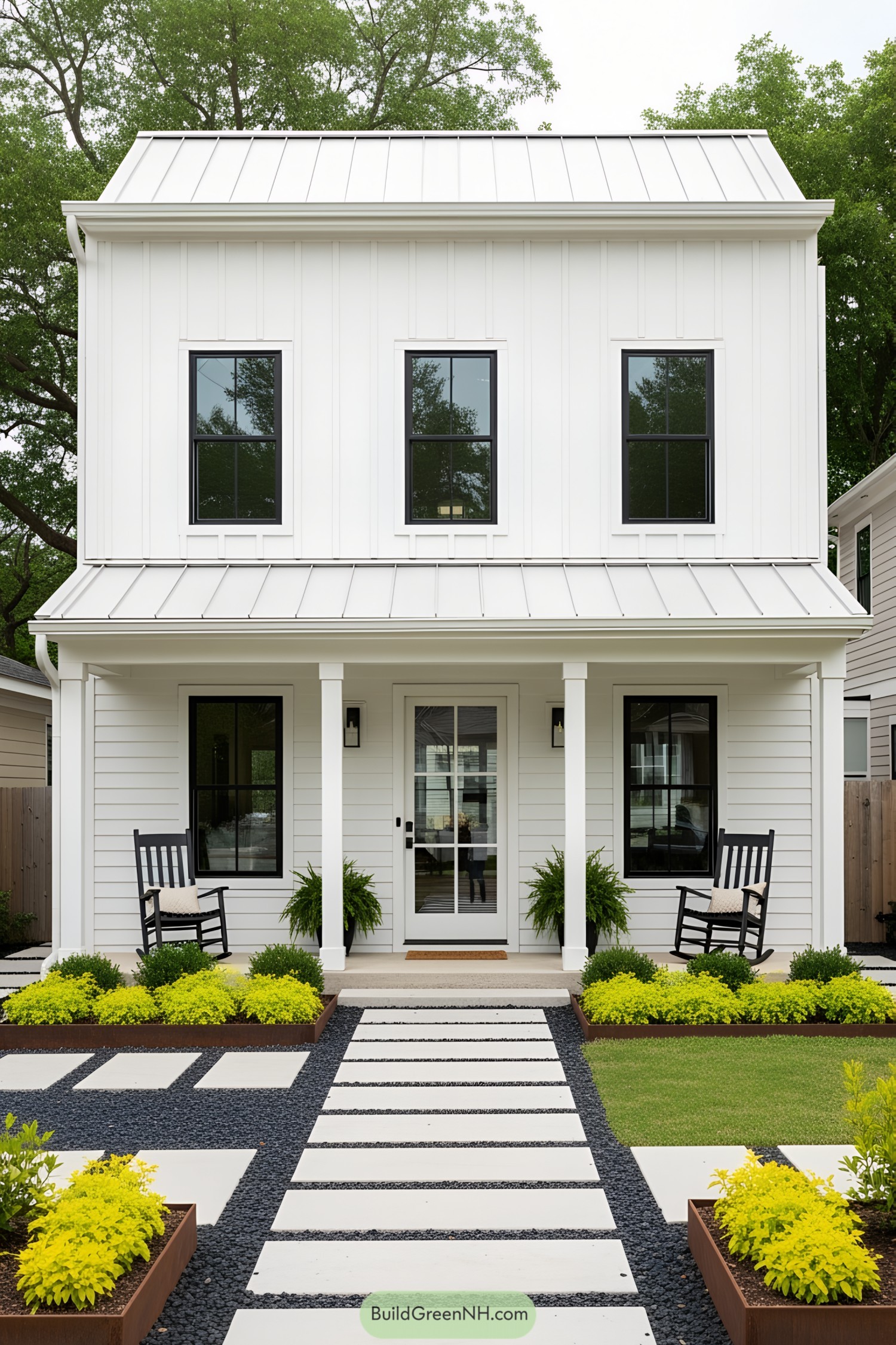 Small white house with black windows and rocking chairs on the porch