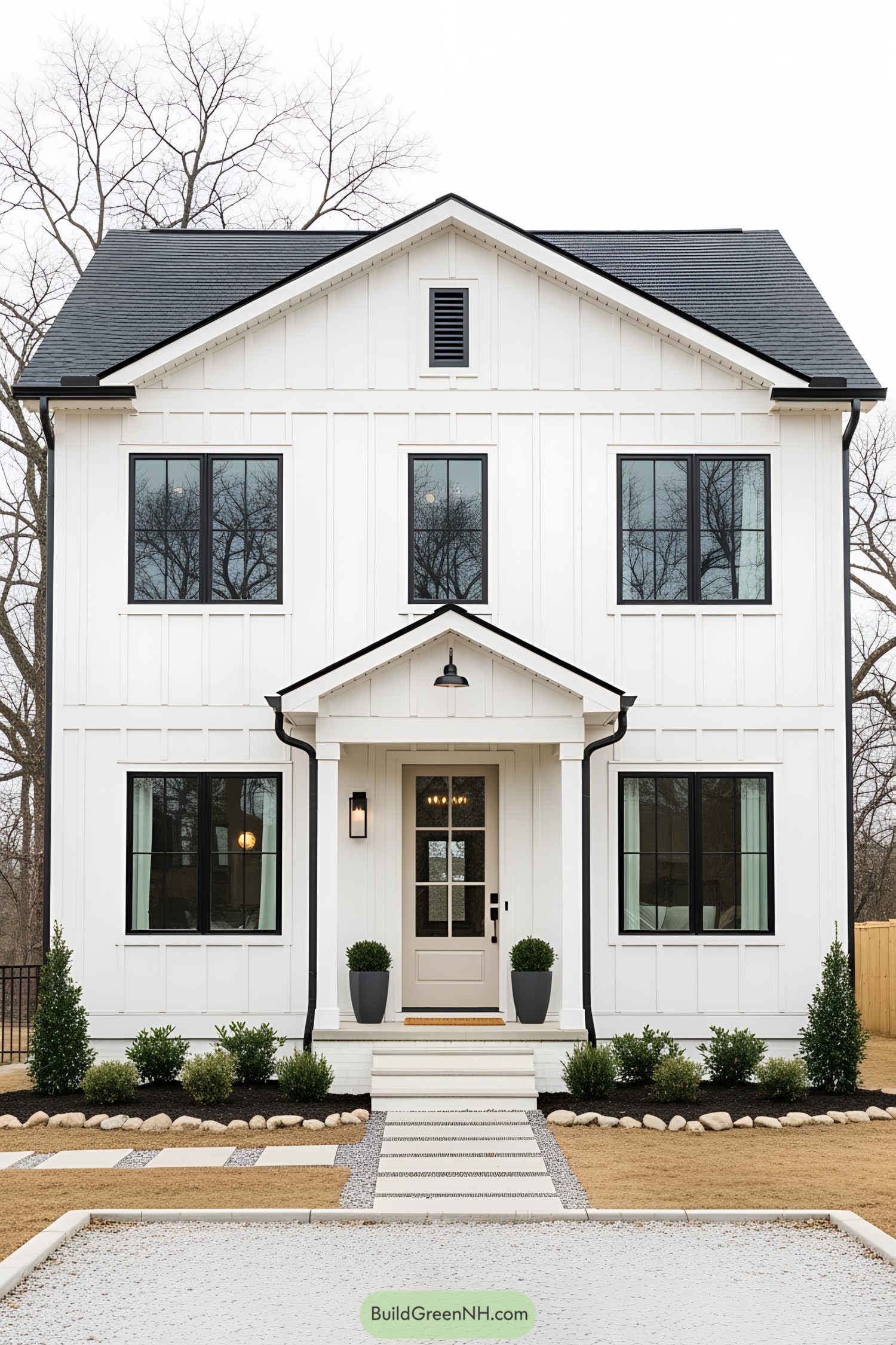 Picture of a charming white house with modern design and black-framed windows