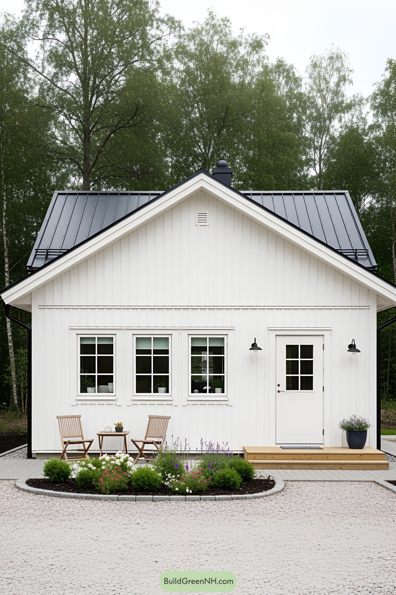Compact white house with black roof, wooden porch, and front garden