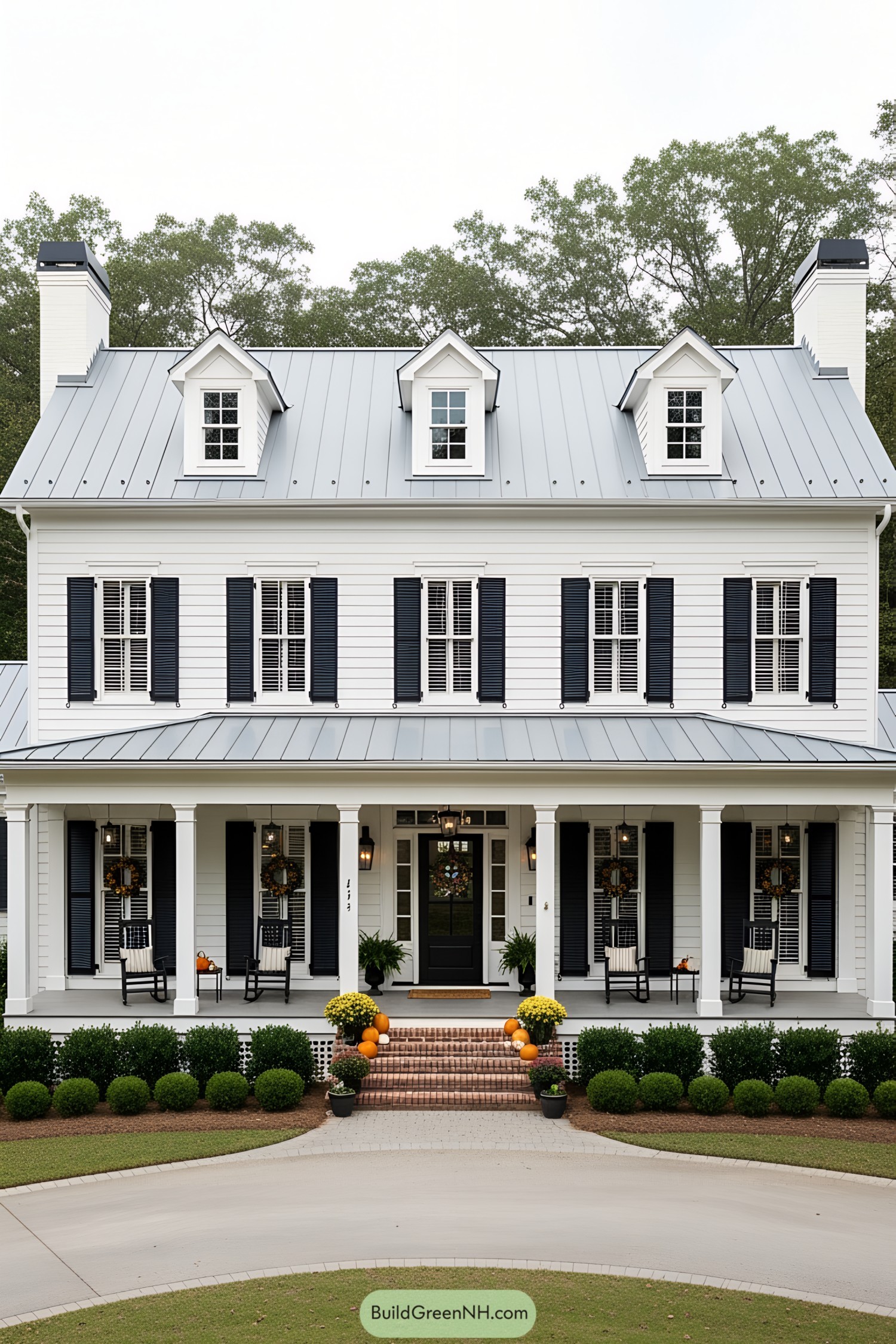 White farmhouse with porch and pumpkins