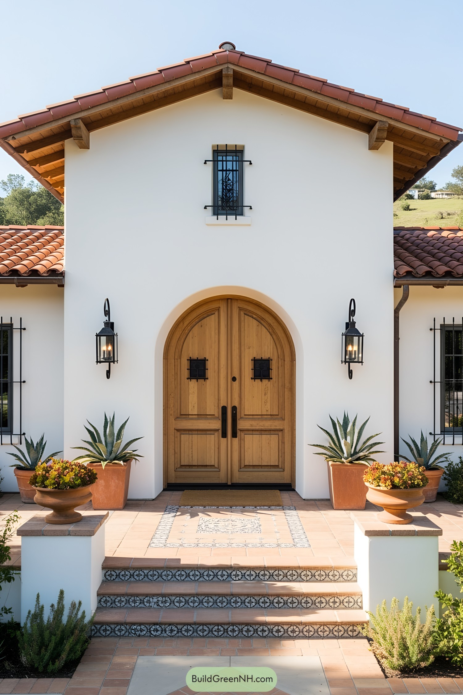 White stucco facade with wooden doors and terracotta tiles