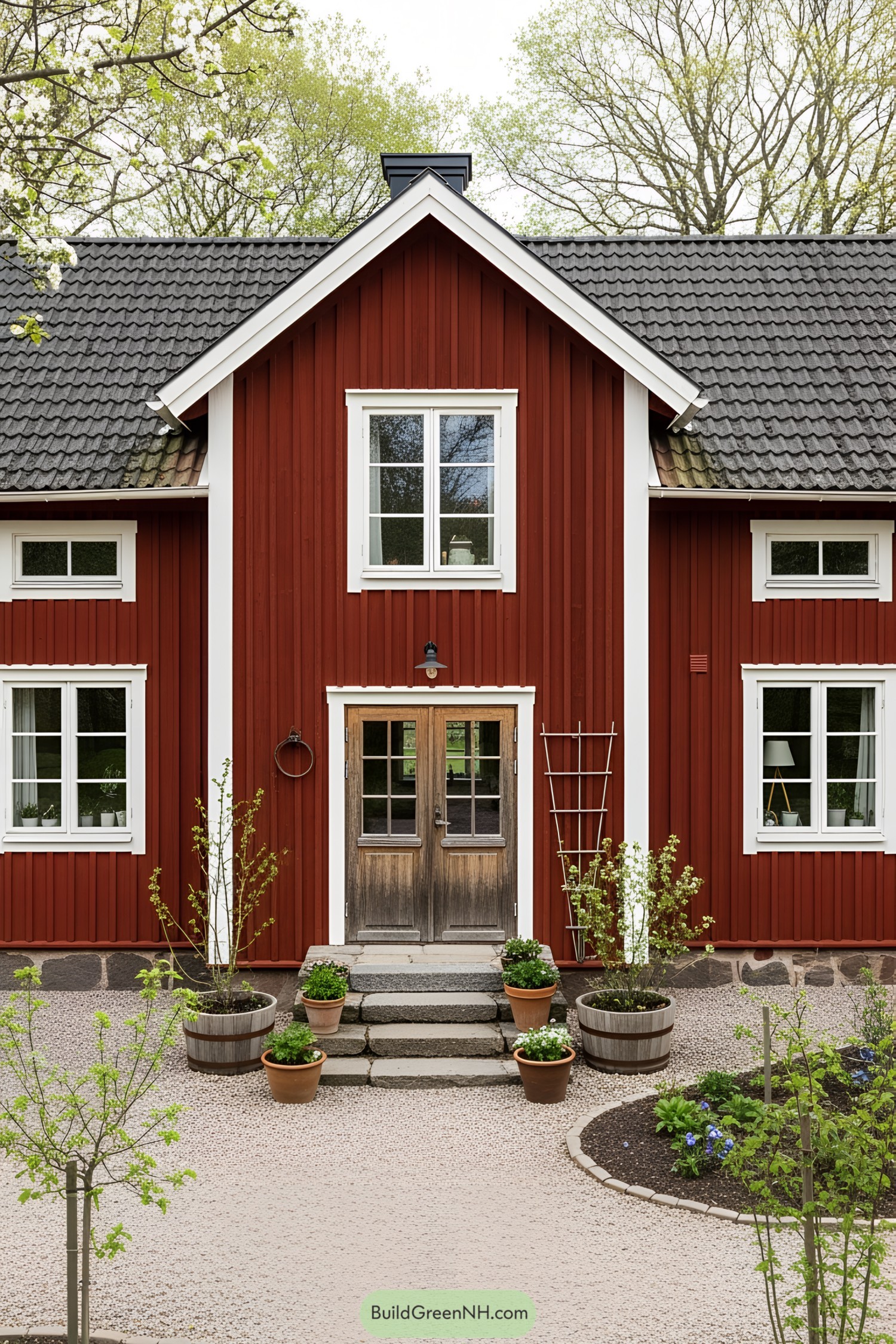 Red farmhouse with white trim and charming garden décor