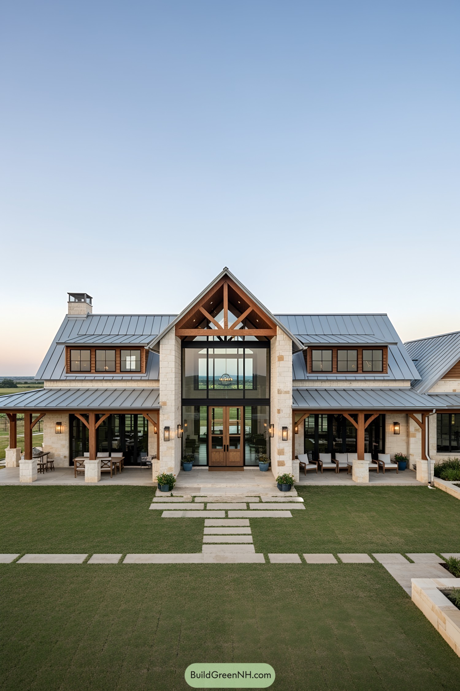 Elegant stone ranch house with a gabled roof and expansive lawn