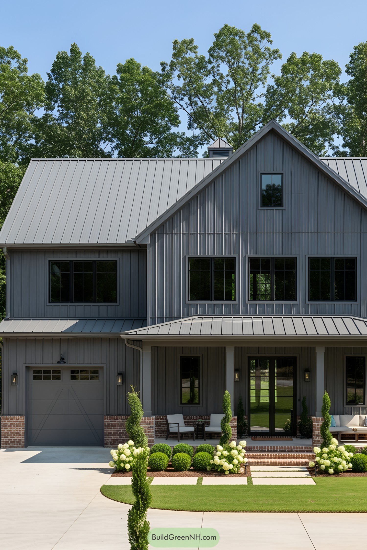 Elegant gray barndominium with inviting porch and manicured landscape