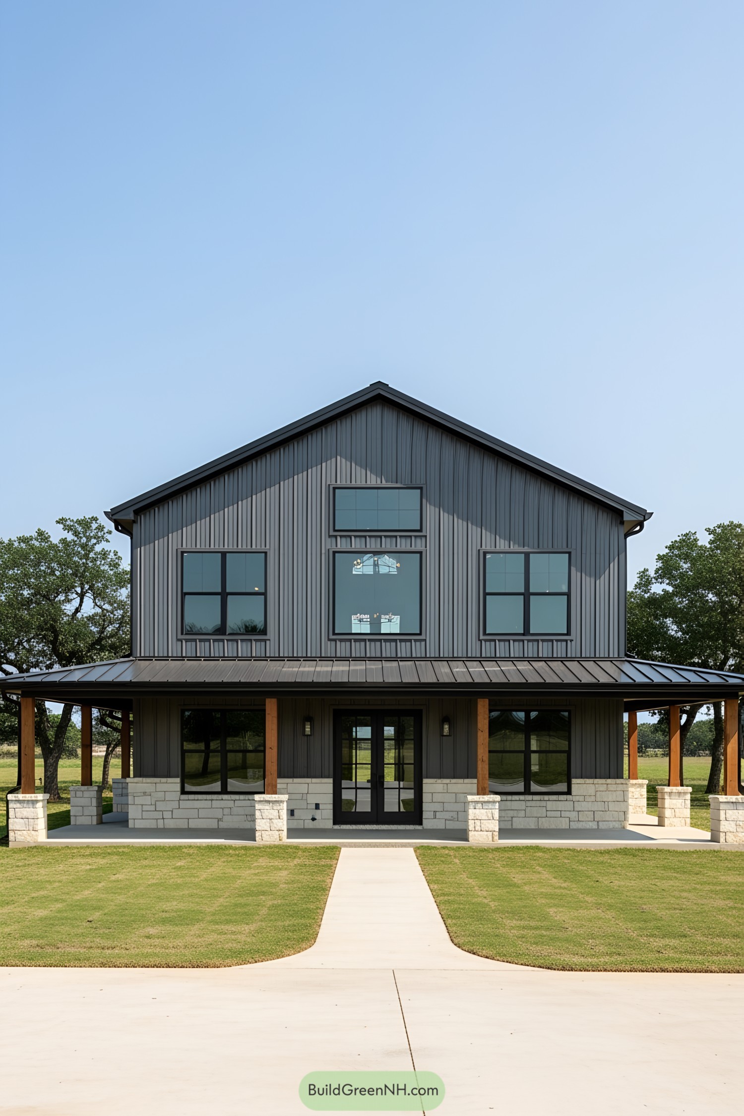 Front view of a modern two-story barndominium with stone accents