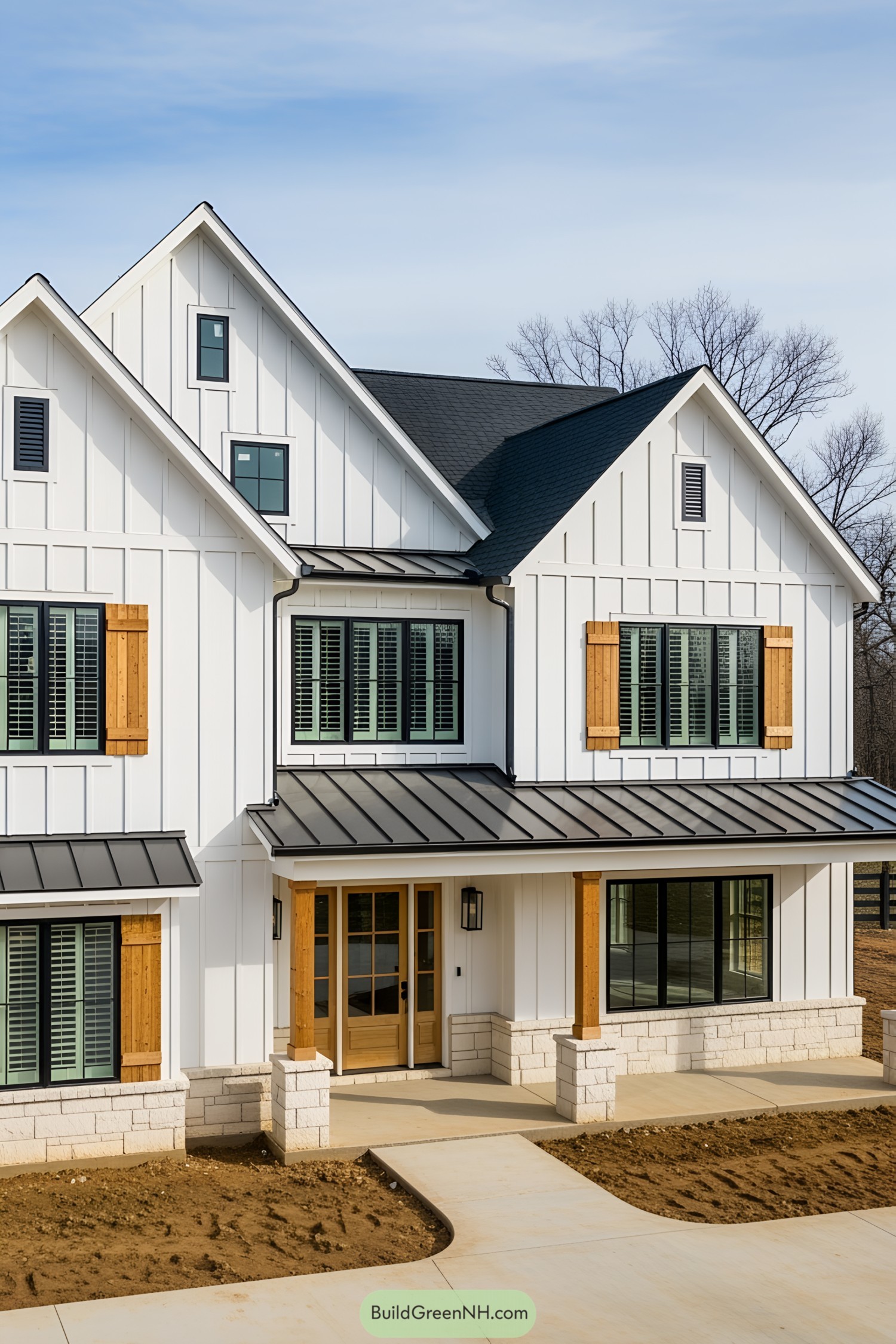 White two-story farmhouse with black roof and wooden shutters