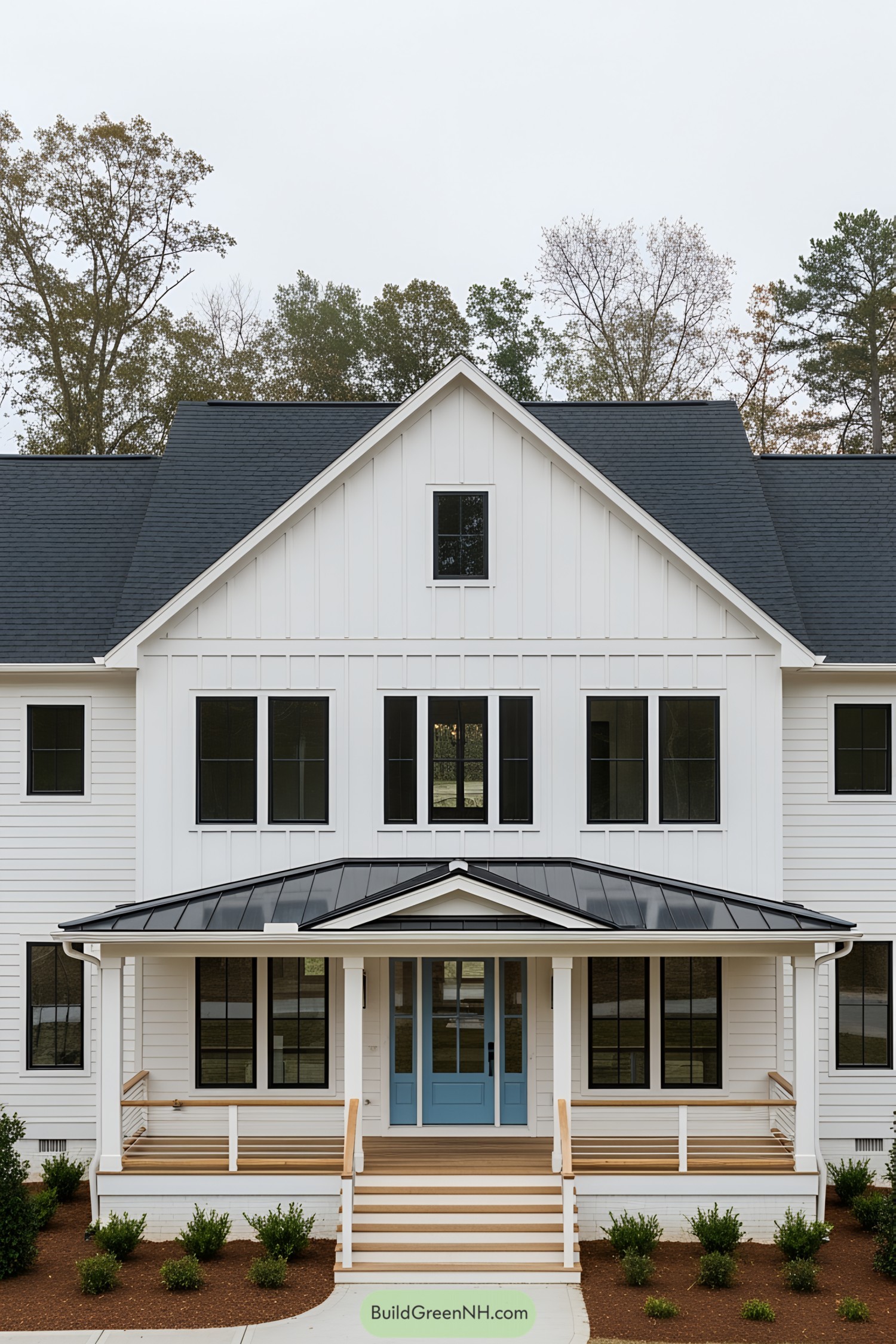 A modern white farmhouse with a blue door