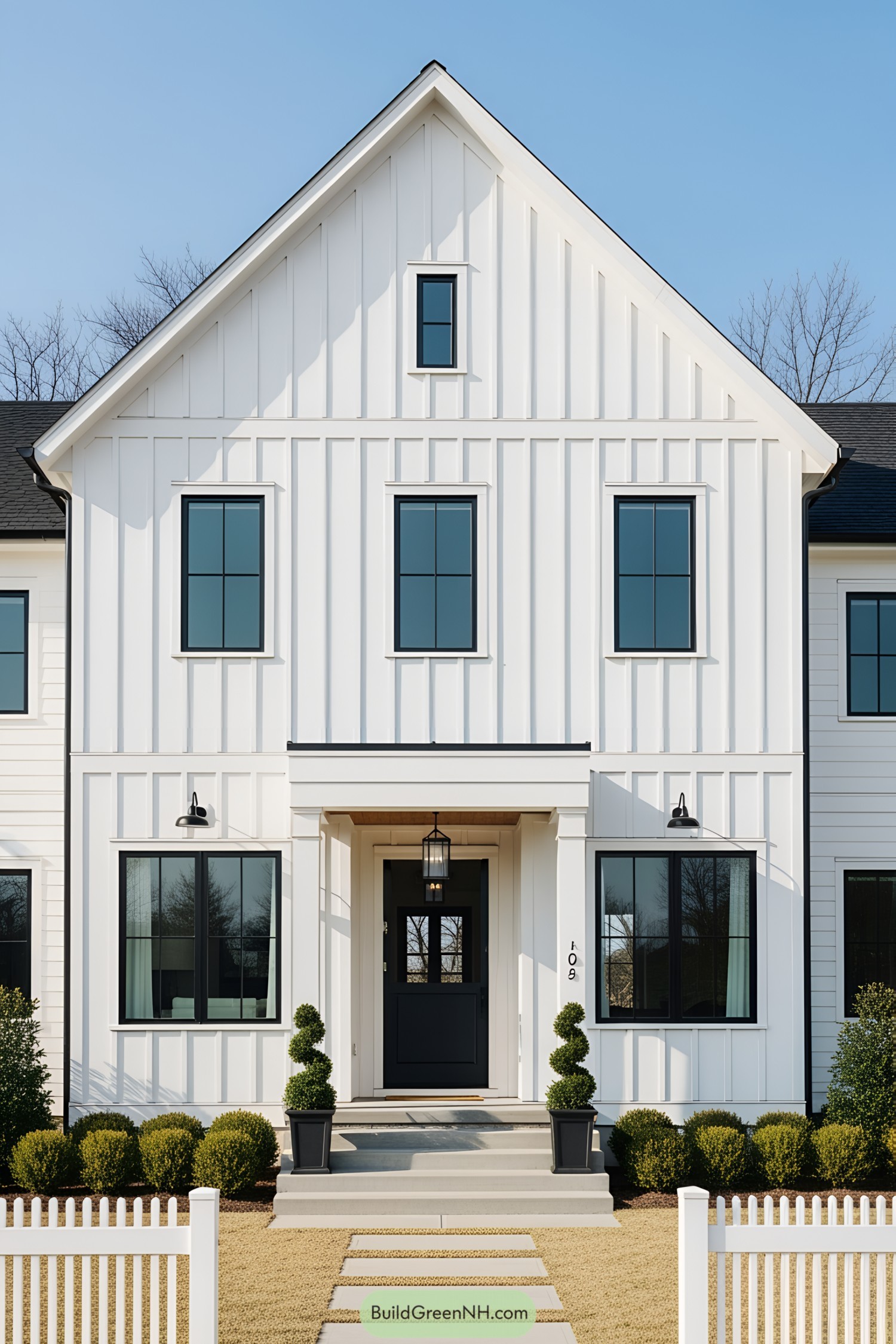 Modern white farmhouse with black window accents and a welcoming entrance