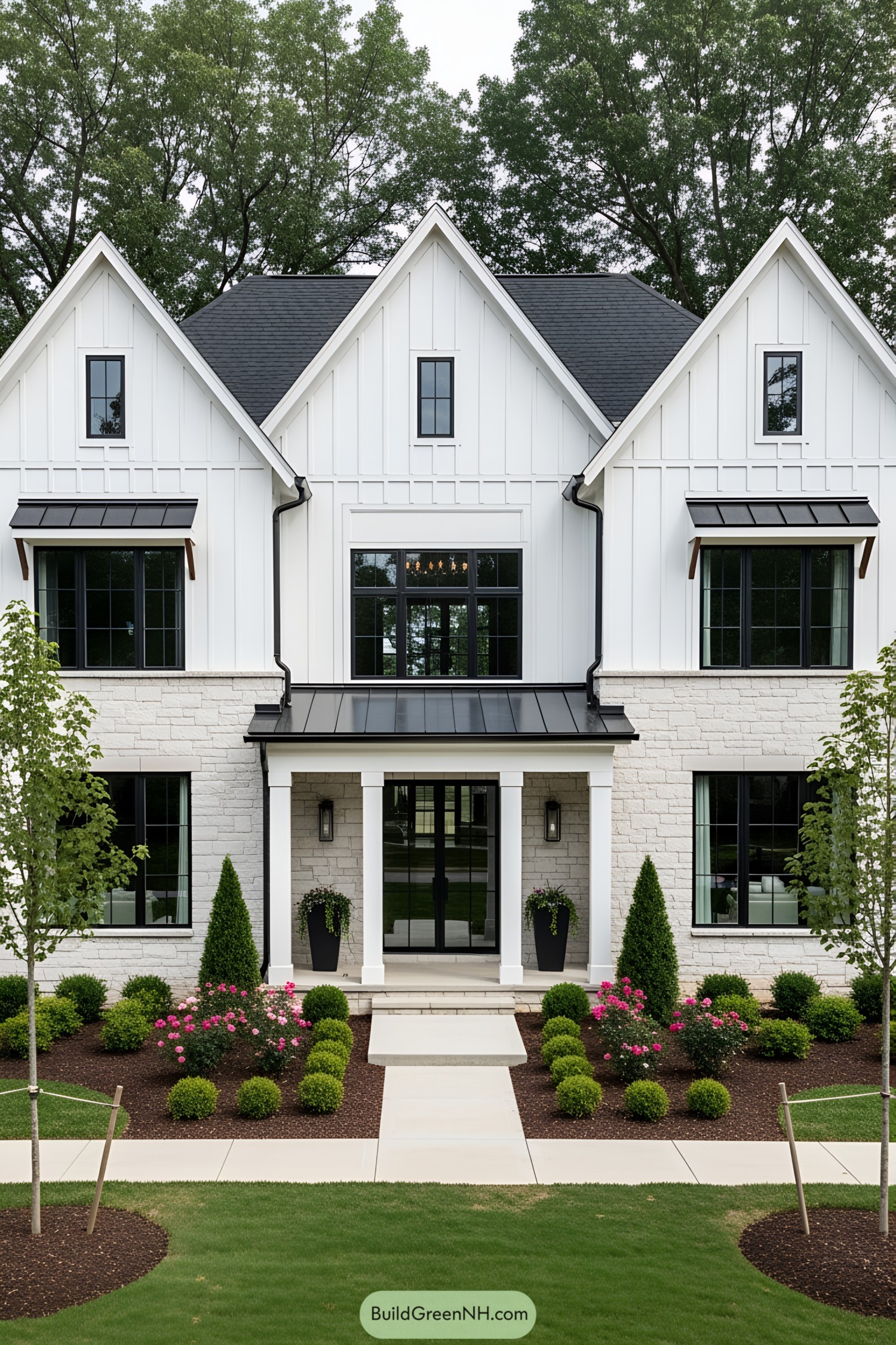 A sleek white farmhouse with manicured landscaping